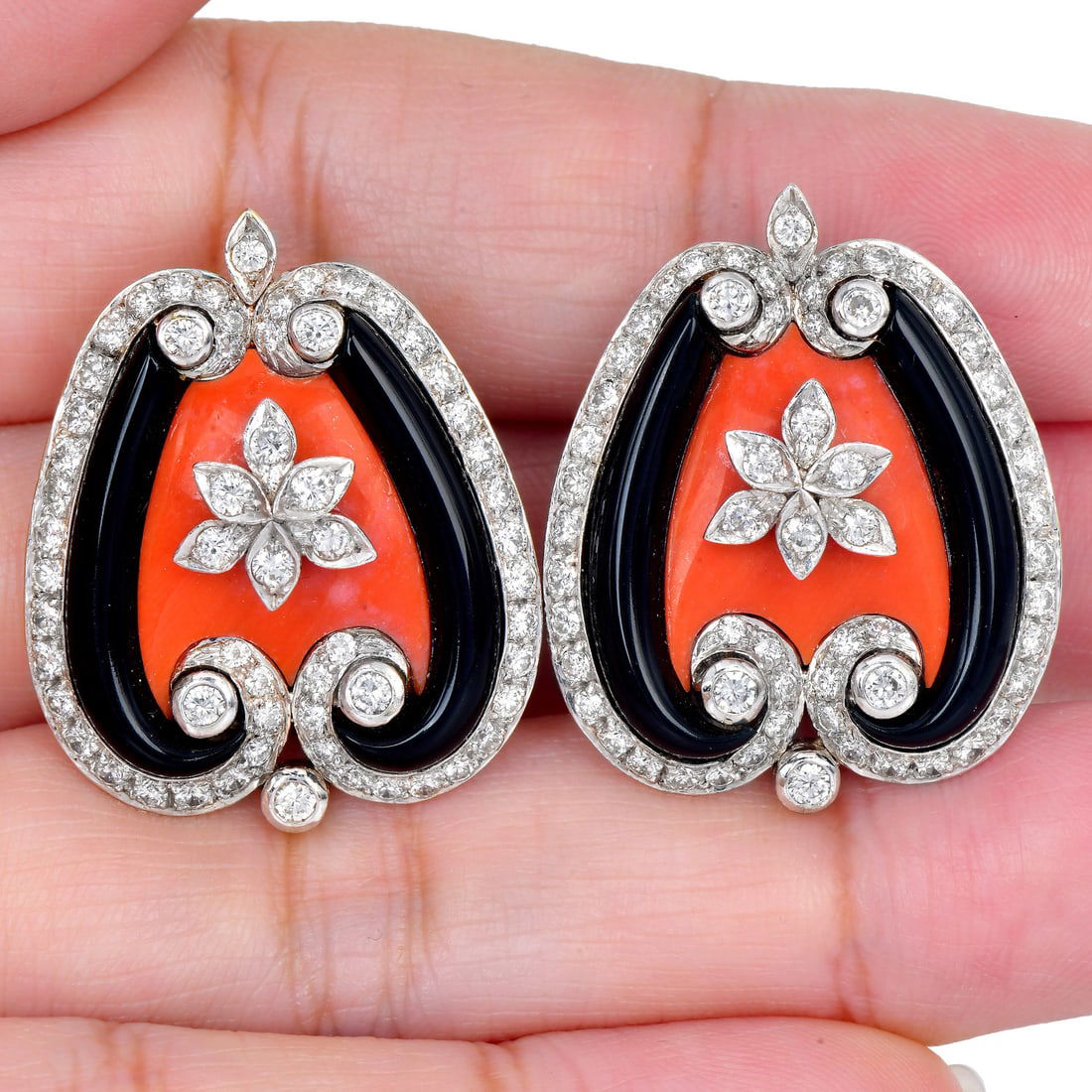 Vintage Coral, Onyx 2.00ct Diamond 18K Gold Stud Earrings 22.1 Grams: Item: Vintage Coral, Onyx & Diamond Stud Earrings Description:Vintage carved coral and onyx stud earrings mounted in 18 karat yellow and white gold. The earrings are accented by approximately 2.00 car