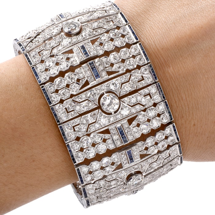 Art Deco 50.06cts Diamond Sapphire Platinum Wide Bracelet 122.8 Grams: This stunning vintage bracelet is inspired by an Art Deco motif and crafted in luxurious platinum. Through the center and along both outer edges are French-cut sapphires, elegan