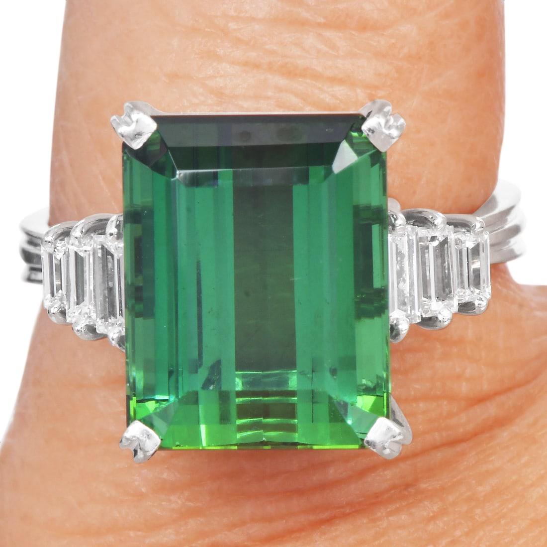 Green Tourmaline 6.60ct Diamond 18K White Gold Ring 6.5 Grams: Item: Green Tourmaline, Diamond & 18K White Gold Ring Description:Ring crafted in 18 karat white gold, featuring a rectangular green tourmaline weighing approximately 6.00 carats. The center stone mea