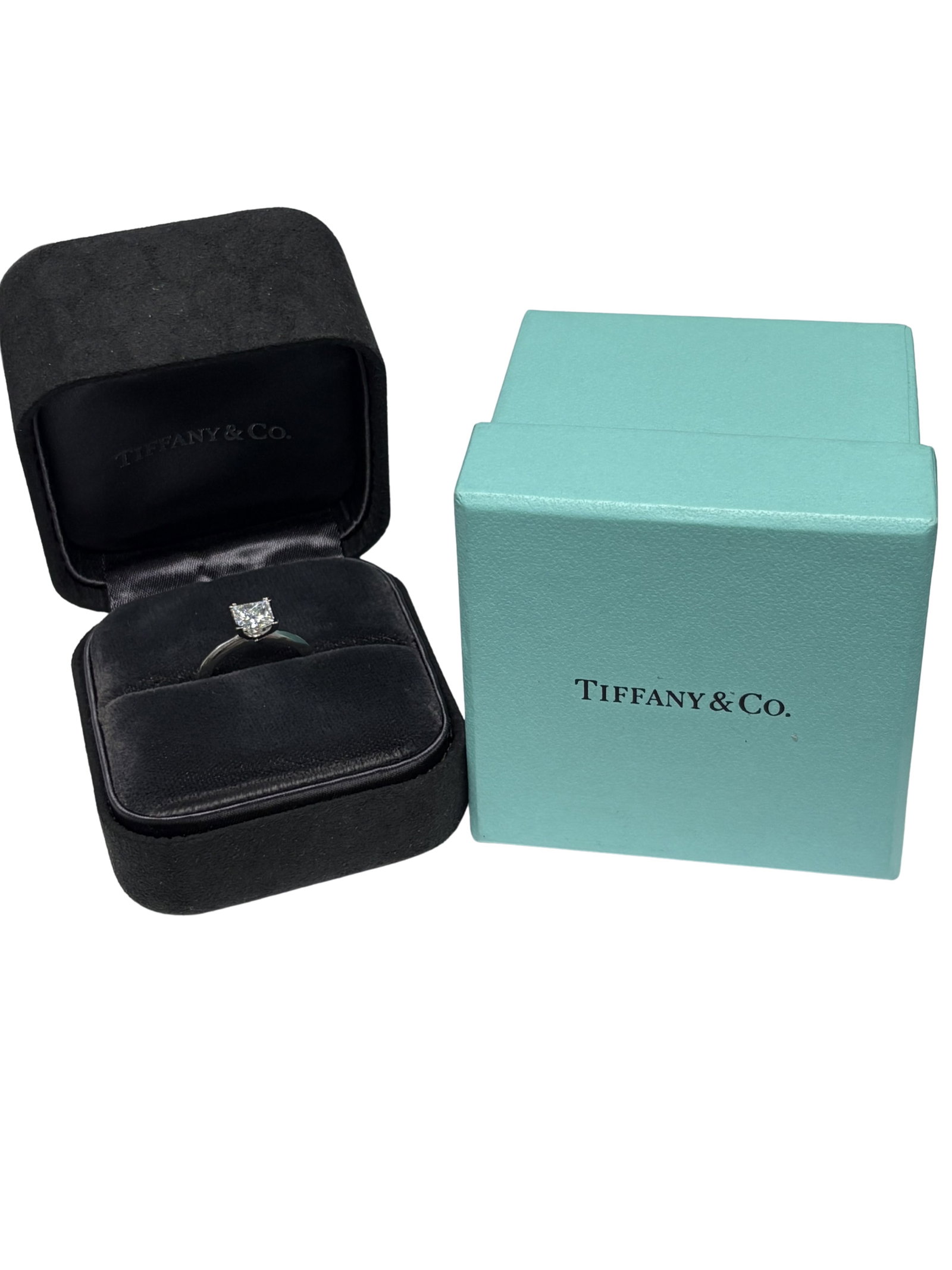 Tiffany & Co 1.17ct Princess Cut Diamond Platinum Solitaire Engagement Ring Retail $23,200: An iconic Tiffany & Co. solitaire engagement ring crafted in platinum and set with a dazzling princess cut diamond weighing approximately 1.17 carats. The center diamond is graded E color and VVS1 cla
