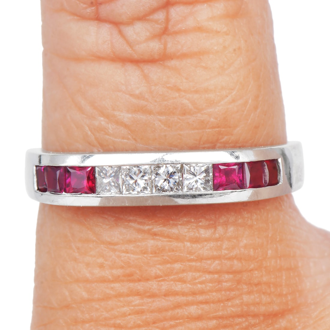 Ruby 0.55ct Diamond 18K White Gold Stackable Band Ring 3 Grams: Ruby Diamond 18K White Gold Ring Beautifully crafted in luxurious 18K white gold, this elegant ring features a vibrant arrangement of natural rubies accented by sparkling diamonds. The rich red hue of
