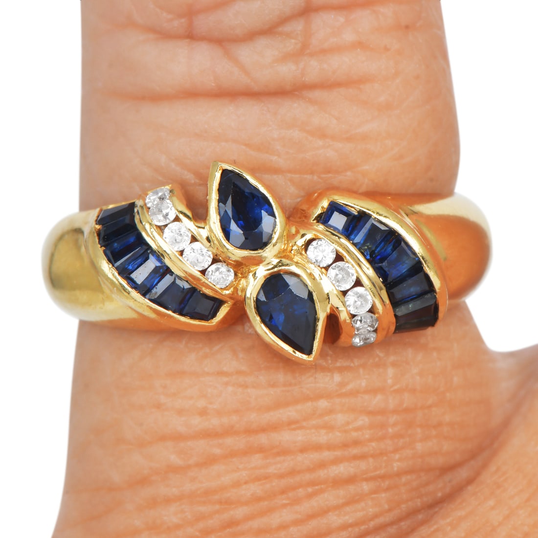 Vintage Sapphire 0.95ct Diamond 18K Yellow Gold Bypass Design Ring 4.1 Grams: Sapphire Diamond 18K Yellow Gold Bypass Design Ring Elegant and contemporary, this ring is crafted in rich 18K yellow gold and features a graceful bypass design accented with vibrant sapphires and