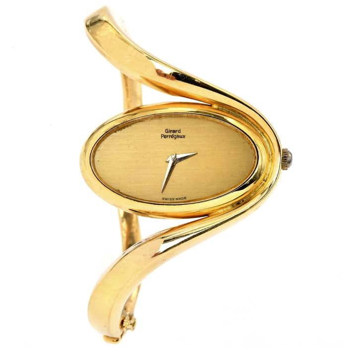 Girard-Perregaux 1980s 18K Gold Oval Dial Bangle Watch 77 Grams: This Vintage 1980s Girard-Perregaux solid gold bangle watch. This collectible Vintage piece is crafted in highly polished 18K Yellow Gold, weighing 77.0 grams and measuring 6? around th