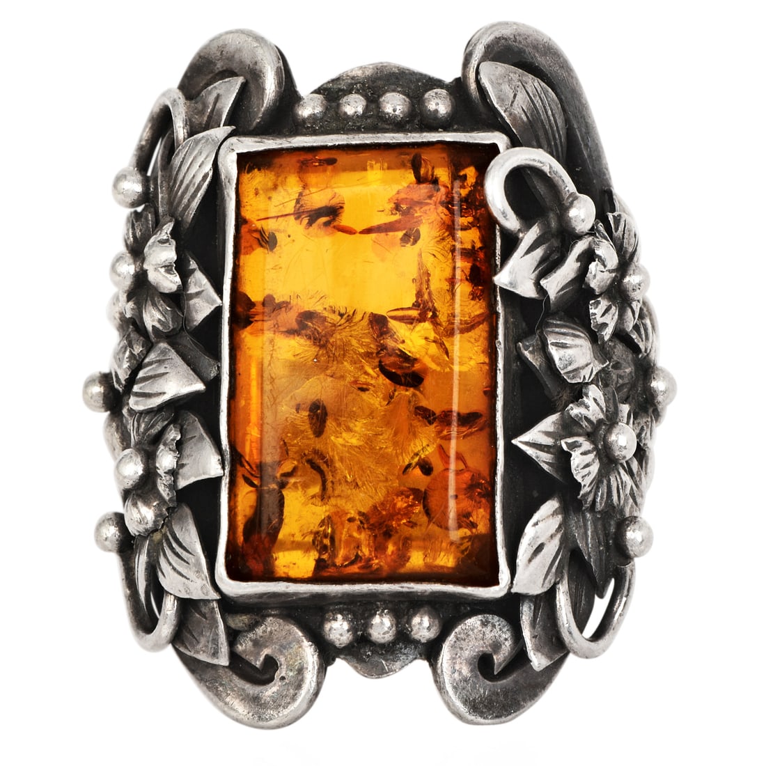Vintage Amber Sterling Silver Brutalist Cocktail Ring with Floral Detail: Vintage Amber Sterling Silver Brutalist Cocktail Ring with Floral Detail DESCRIPTION: Bold vintage cocktail ring featuring a large emerald-cut shaped amber cabochon bezel set within a sculptural Bruta