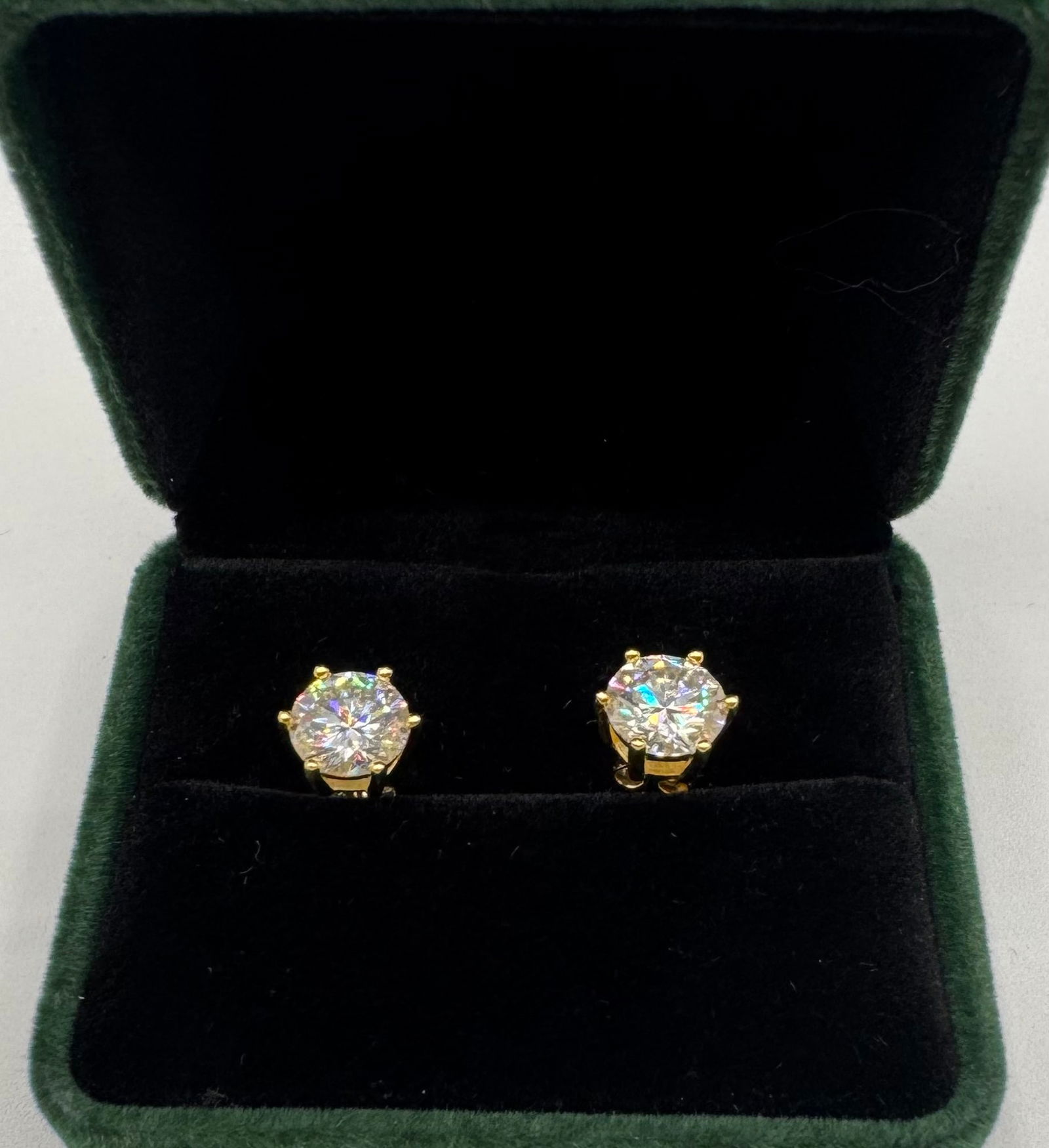 Moissanite Earrings Mounted in Sterling W/ Yellow Gold Overlay, COA: 2 Carats Moissanite Each Earring Total Of 4 Carats Mounted in Sterling with Yellow Gold Overlay, with Certificate Of Authenticity & Jewelry pouch.
