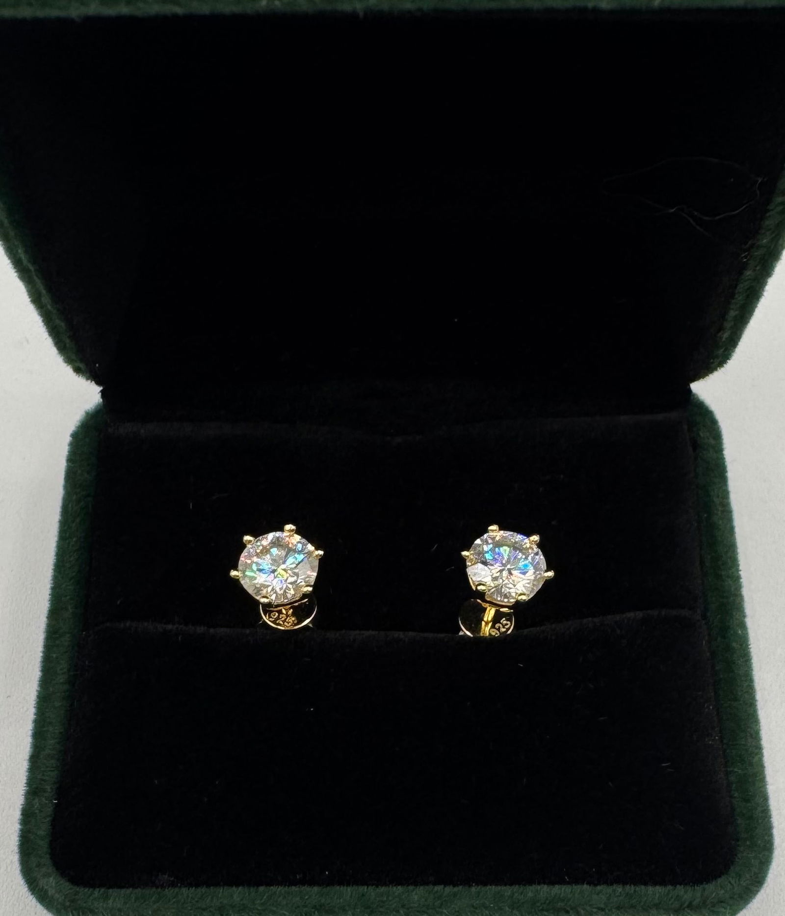 Stud Moissanite Earrings Mounted in Sterling W/ Yellow Gold Overlay, COA: 1 Carats Moissanite Each Earring Total Of 2 Carats Mounted in Sterling with Yellow Gold Overlay, with Certificate Of Authenticity & Jewelry pouch.