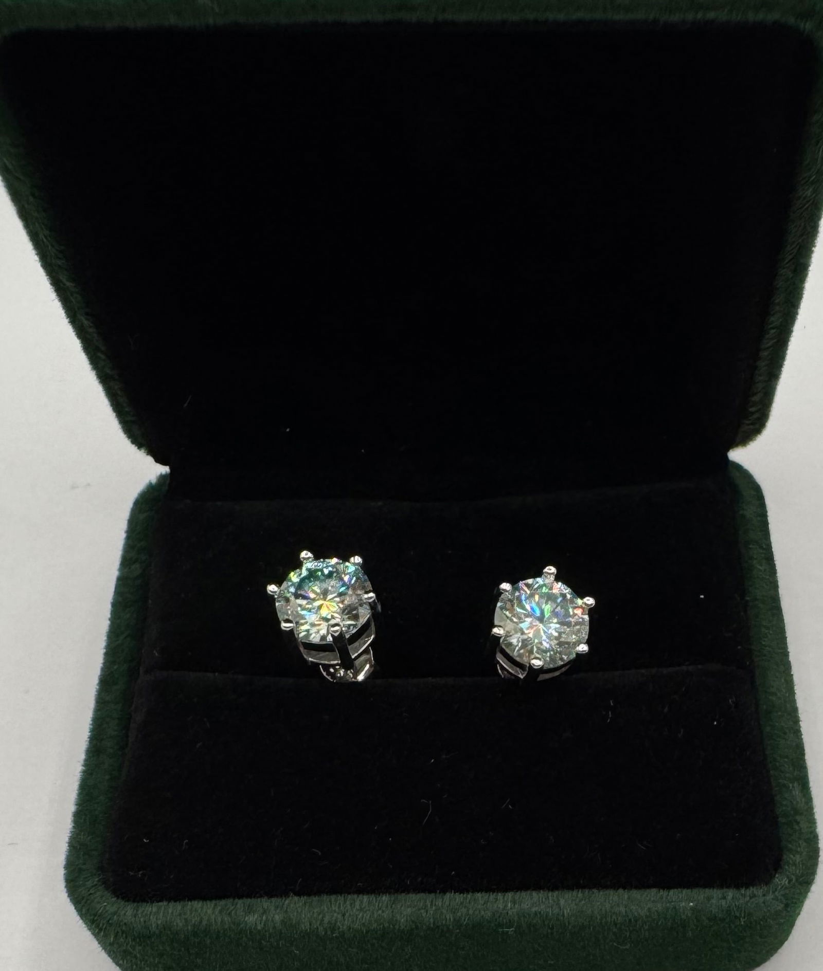 Pair Of 4 Carats Earrings Moissanite With Certificate Of Authenticity: 18k White Gold Plated on Sterling Silver Earrings Moissanite VVS1 Stone shape : Round Color: D Certificate: GRA Weight: 2 Carats each total of 4 carats Real Moissanite