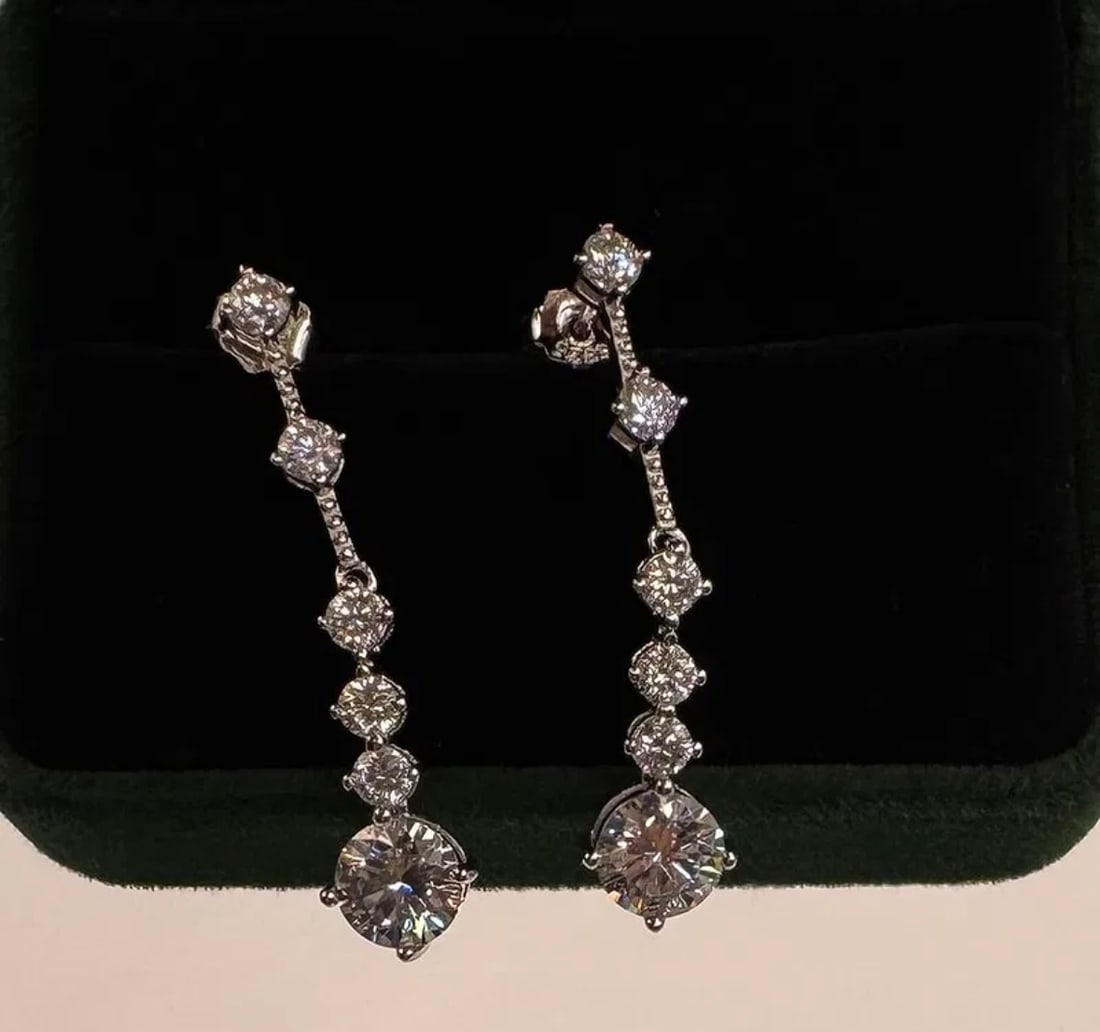 Pair Of 4 Carats Earrings Moissanite With Certificate Of Authenticity: 18k White Gold Plated on Sterling Silver Earrings Moissanite VVS1 Stone shape : Round Color: D Certificate: GRA Weight: 2 Carats each total of 4 carats Real Moissanite