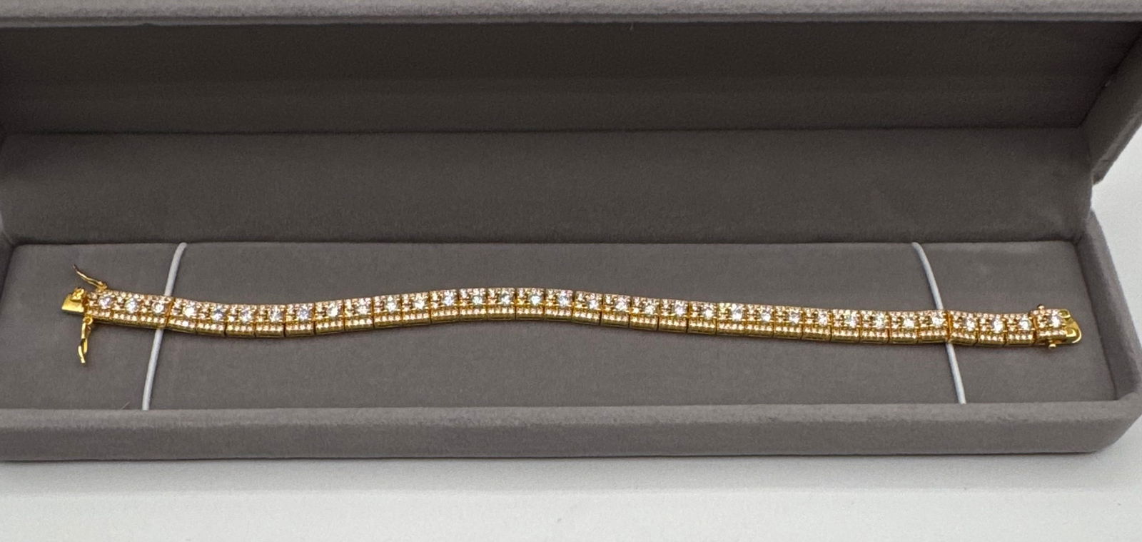 Double Row Moissanite Bracelet 18k YG Over 925: A luxurious take on a classic silhouette, this double-row Moissanite tennis bracelet offers unmatched fire and brilliance. The piece features two rows of precision-cut stones set in 18k yellow gold pl