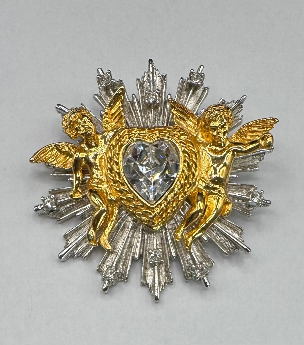 Kirks Folly 1997, Angel Cherub Pin, Crystal Heart, Celestial Sunburst, Mixed Metal Jewelry: This is a stunning, multi-dimensional Kirks Folly statement piece dated 1997. True to the brand's whimsical aesthetic, this piece features a central heart-shaped faceted crystal flanked by two highly 