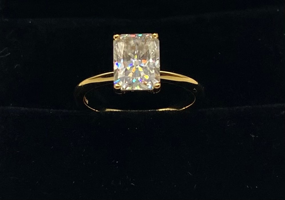 Radiant Cut Moissanite VVS Ring - 18k Yellow Gold Finish: A sophisticated and modern classic featuring a 3.00-carat Radiant cut Moissanite. This elongated cut is known for combining the elegant lines of an emerald shape with the brilliant sparkle of a round