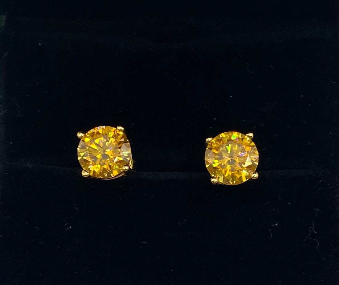 4.00 CTW Vivid Yellow Moissanite Stud Earrings – 18K Gold over Sterling: vivid yellow moissanite studs. Each earring features a 2.00-carat round brilliant cut stone (4.00 CTW total), showcasing a deep, saturated golden hue that mimics the rarest fancy colored diamonds.