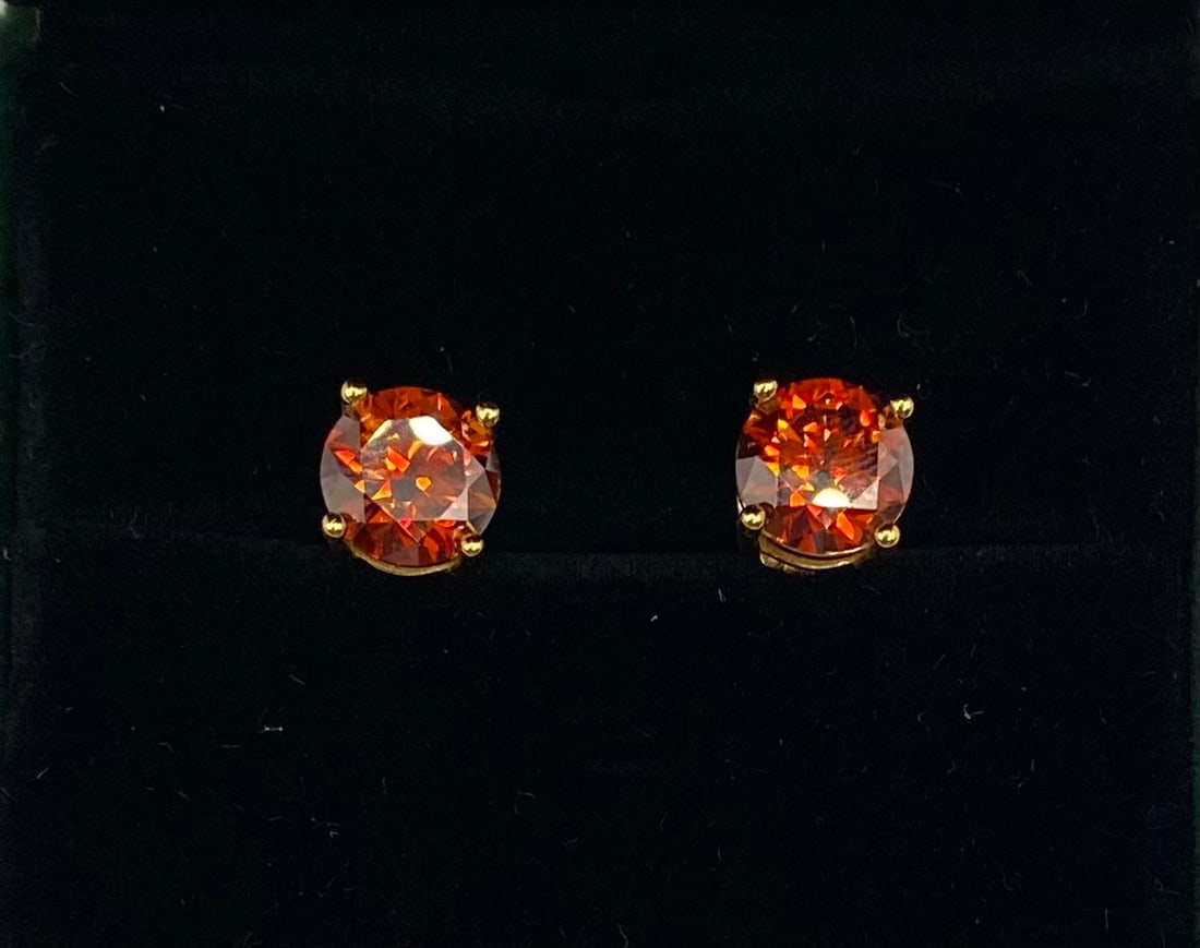 4.00 CT Red Moissanite Stud Earrings – 18K Gold over Sterling: Sophisticated and bold, these cognac-orange moissanite studs offer a unique, warm aesthetic. Featuring two 2.00-carat round brilliant cut stones for a total of 4.00 CTW, these earrings capture a rich,