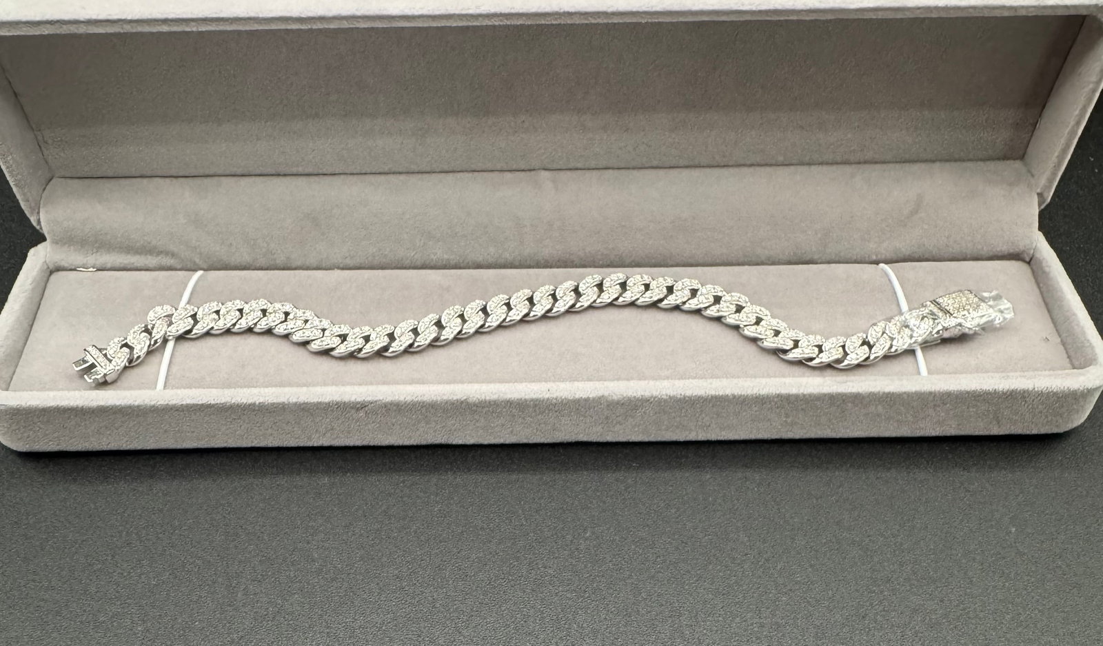 Moissanite Iced-Out Cuban Link Bracelet - 18k White Gold Plated Sterling Silver: This lot features a premium "iced-out" Cuban link bracelet, designed for maximum brilliance and high-end appeal. Set with high-quality moissanite stones throughout the links and clasp, this piece
