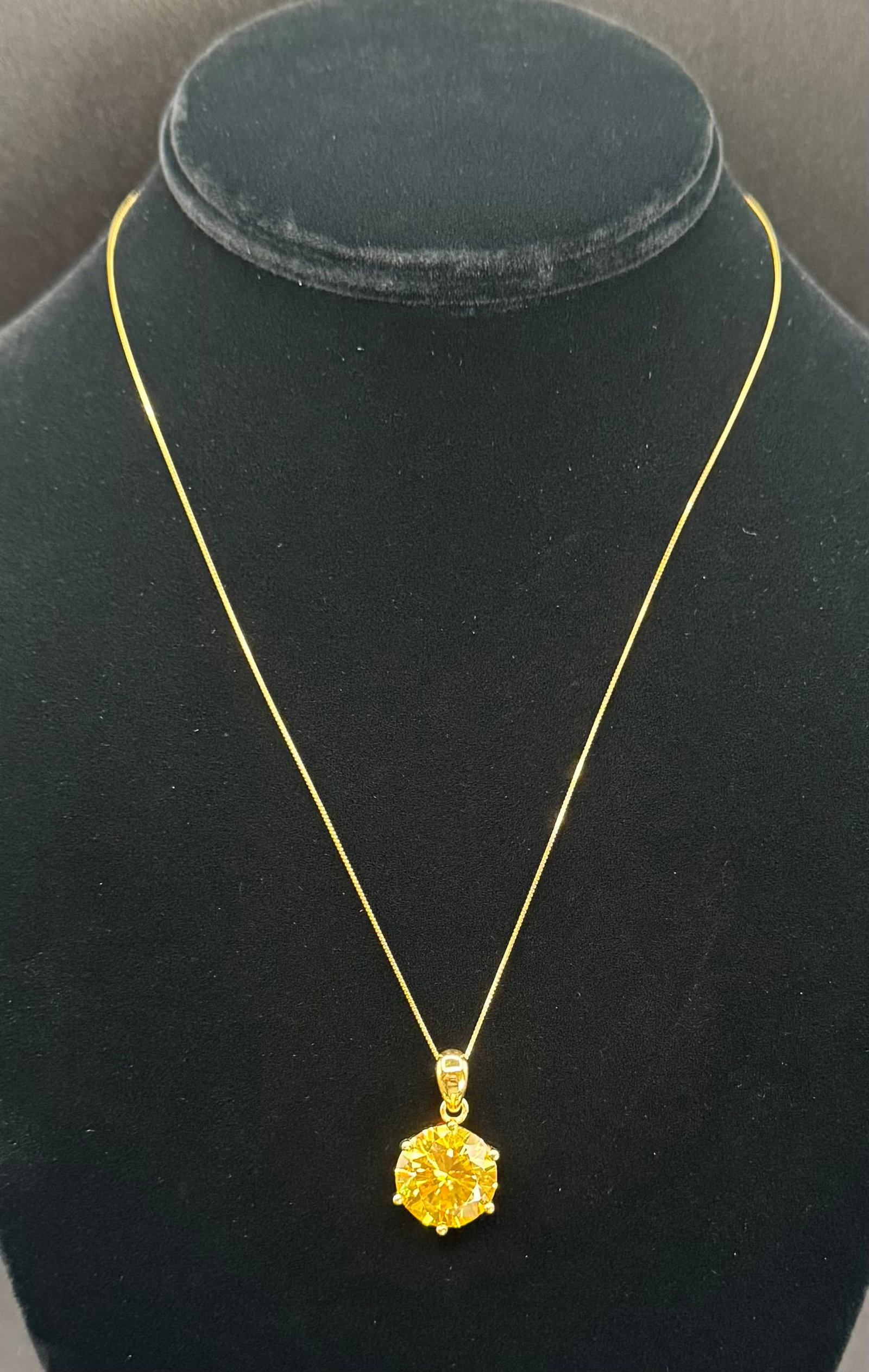 10 Carat Canary Yellow Moissanite Solitaire Pendant – 18K Gold Plated Sterling Silver – Diamond: Main Stone: 10.00 Carat Round Brilliant Cut Moissanite• Color: Fancy Canary Yellow• Metal: 18K Gold Plated over Sterling Silver• Testing: Professionally tests positive for diamond on st