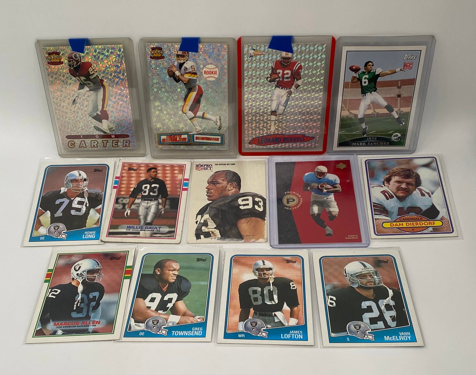 Multi-Era Football Star Lot - Howie Long, Marcus Allen, Dan Dierdorf, Mark Sanchez RC: An eclectic mix of vintage legends and modern stars. Highlights include:• Vintage: Topps cards featuring Hall of Famers Howie Long, Marcus Allen, James Lofton, and Dan Dierdorf.• Inserts/Par