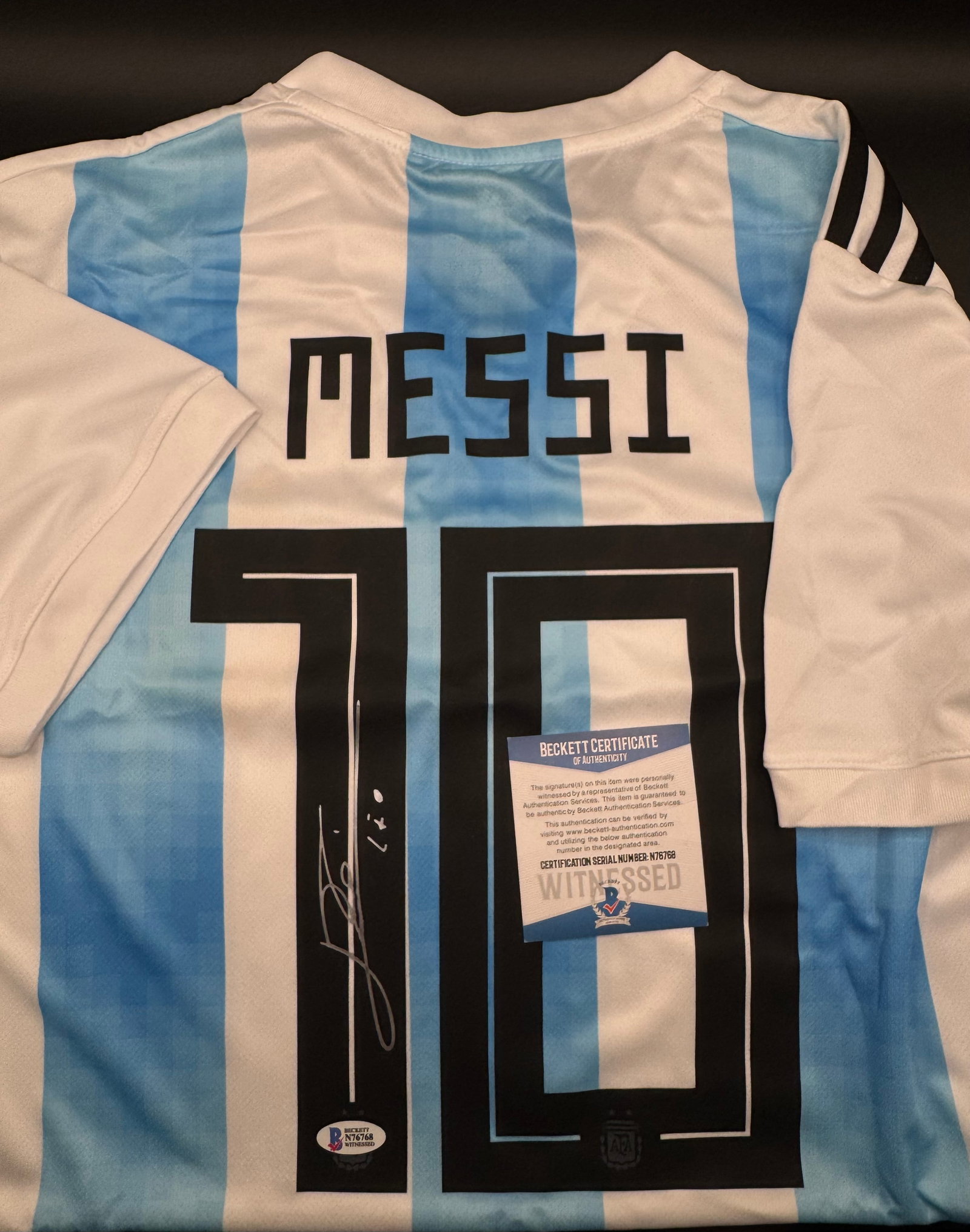 Lionel Messi Signed Argentina National Team Jersey – Beckett Witnessed COA: Celebrate the "GOAT" with this signed Argentina National Team jersey, featuring the name and number of 8-time Ballon d'Or winner, Lionel Messi.• Signature: Boldly signed on the black "1" of the n