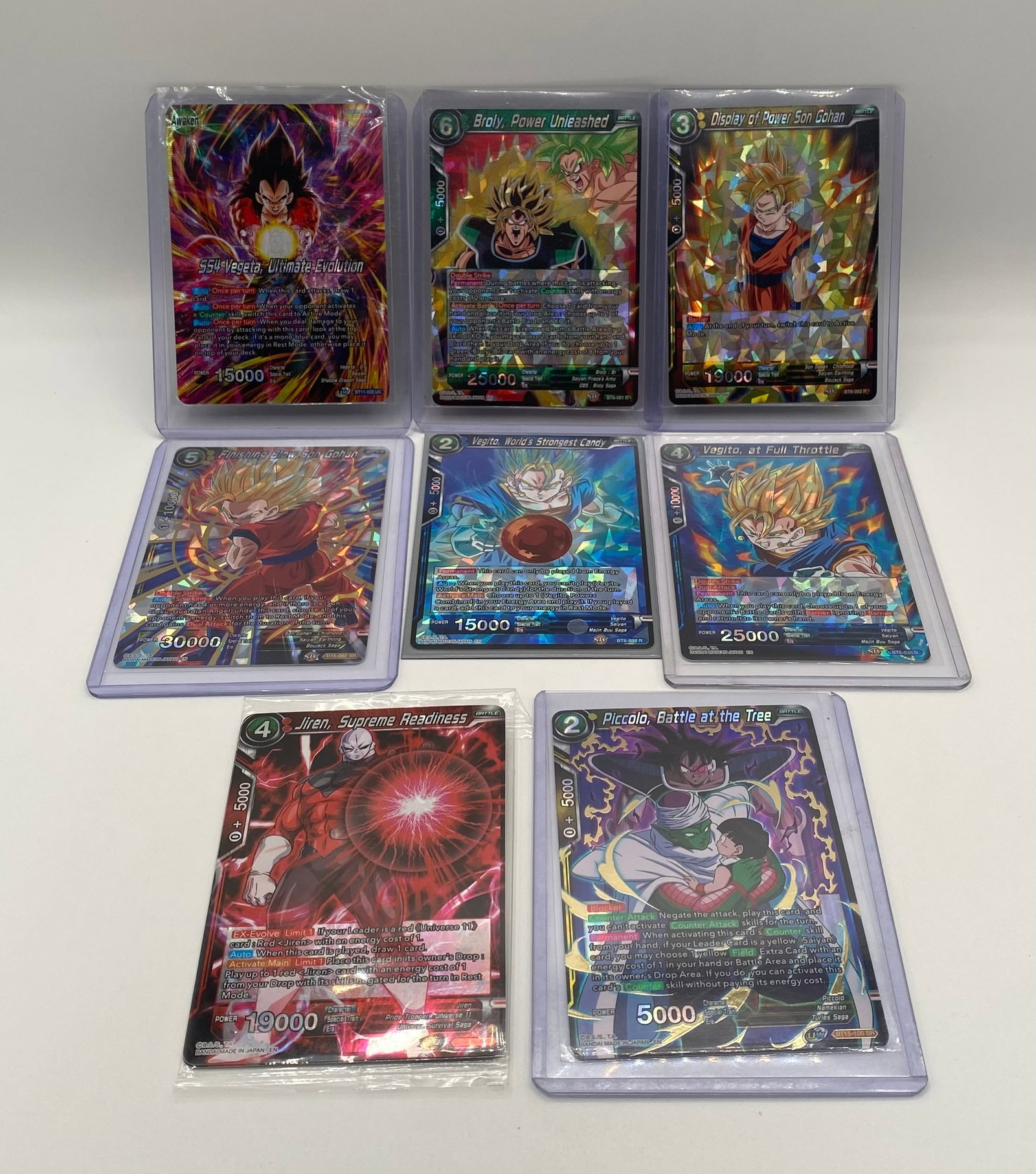 Dragon Ball Super TCG Card Lot (8) incl. Super Rare / Promo Cards: Excellent curated collector lot of eight (8) Dragon Ball Super Trading Card Game cards as shown in image.png. All cards are individually sleeved or housed in top loaders/semi-rigid protectors.
