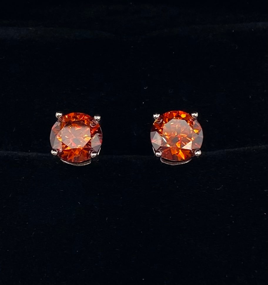 4.00 TCW Round Cognac Moissanite Stud Earrings 18K GP Sterling Silver: Gemstone Type: Authentic Moissanite Total Carat Weight: 4.00 Carats total weight (2.00 carats per earring) Stone Cut/Shape: Brilliant Round Cut Stone Color: Rich Cognac / Burnt Orange Metal Compositio