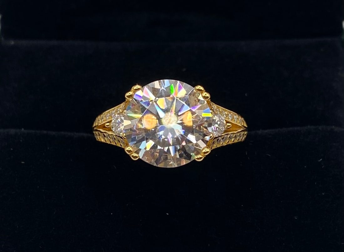 5 CT VVS Moissanite Halo Cluster Ring, 18K White Gold Plated: Center Stone: Moissanite Carat Weight: 5.00 Carats Clarity: VVS Metal: 18K White Gold Plated over Sterling Silver Ring Size: 8 Testing: Confirmed to pass as diamond on standard thermal diamond