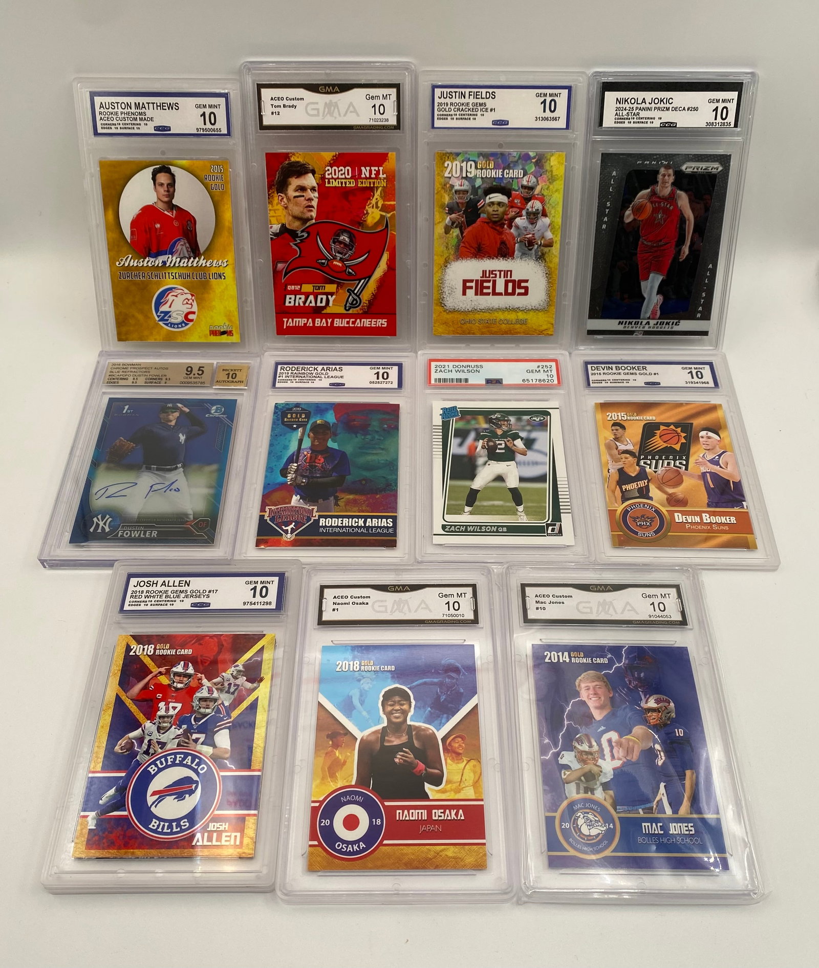 11 Graded Sports Cards Lot: Tom Brady, Nikola Jokic, Justin Fields, Josh Allen (GMA/PSA 10s): Basketball: Nikola Jokic 2024-25 Panini Prizm Deca #250 All-Star (CCG Gem Mint 10), Devin Booker 2015 Rookie Card Phoenix Suns (GMA Gem Mint 10)Football: Tom Brady 2020 NFL Limited Edition Gold #12 Ta