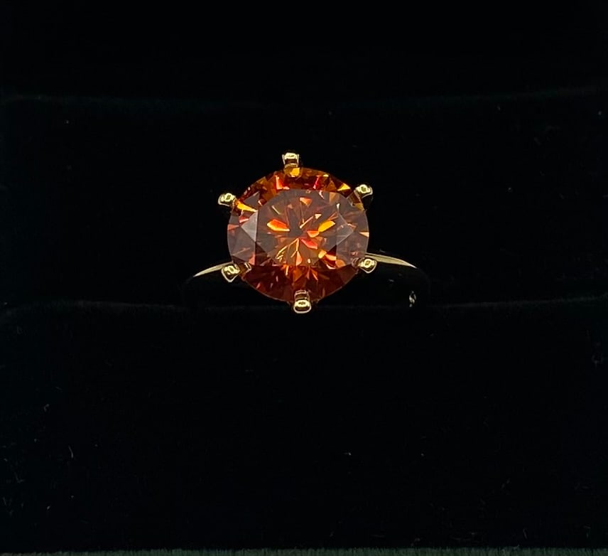 Orange Red 5 Carats Moissanite VVS1 Ring Size 8: 18k Gold Plated Over Sterling Silver Ring with Orange Red VVS1 Moissanite Stone . Ring size: 8 . It comes with a certificate of authenticity.
