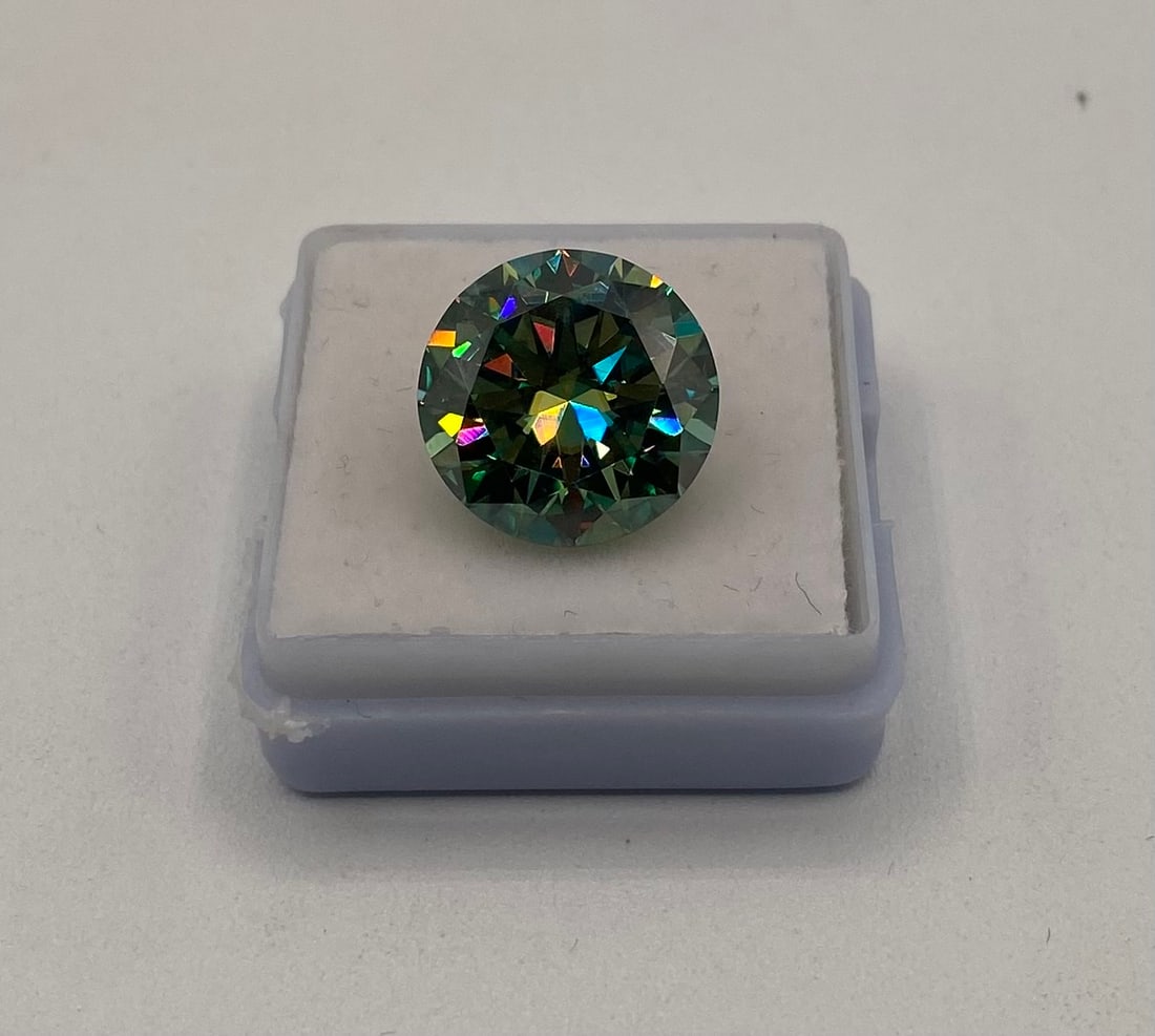10 Carats Blue Green VVS1 Moissanite Stone: 10 Carats Blue Green Color VVS1 Moissanite Stone. It passes for diamond using diamond tester . It comes with a certificate