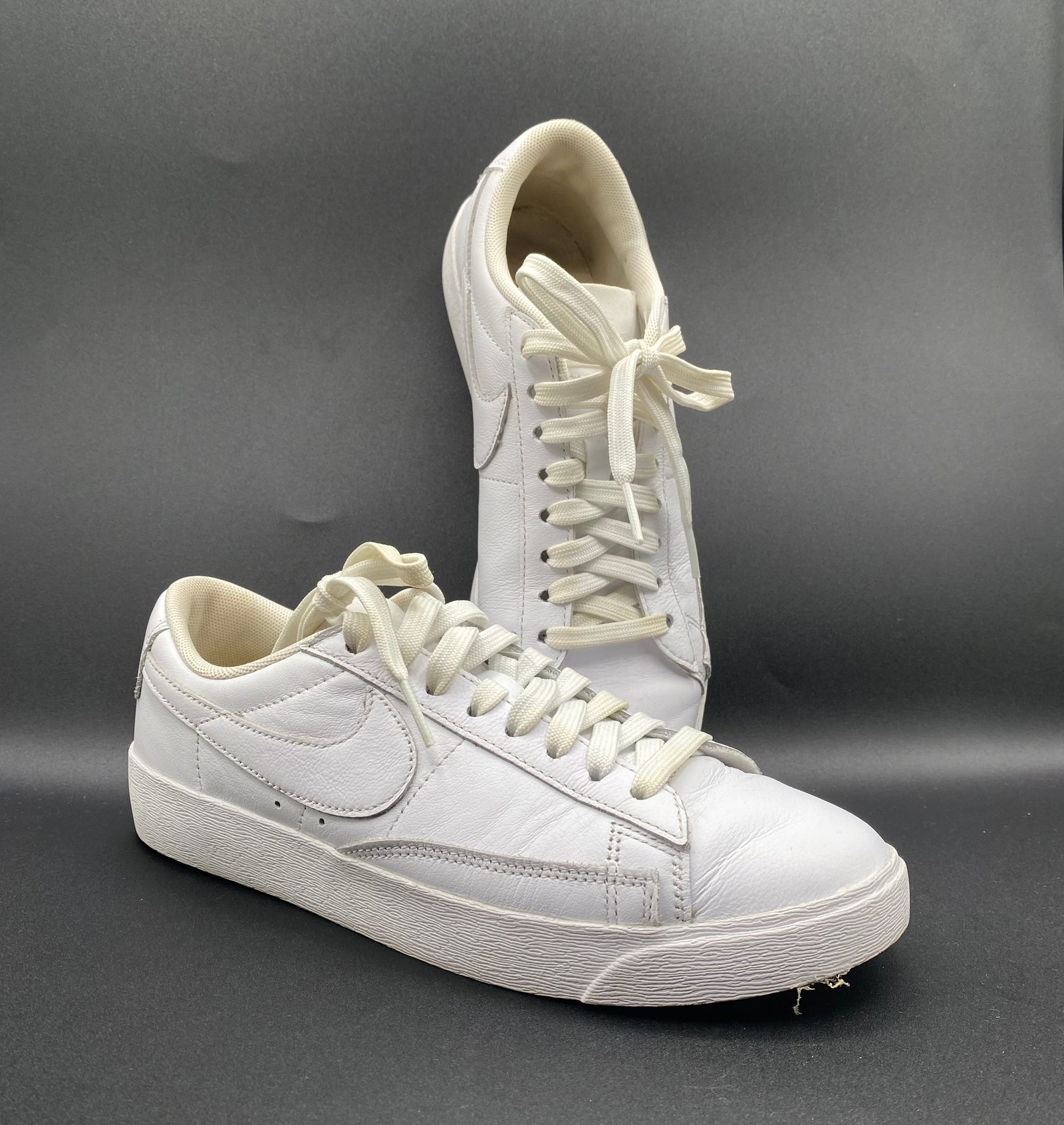 Nike Blazer Low LE "Triple White" Leather Sneakers: Up for auction is a clean pair of Nike Blazer Low LE Sneakers in the classic "Triple White" colorway (Style # AV9370-111). Crafted with smooth, durable leather uppers, retro stitch-and-turn paneling, 