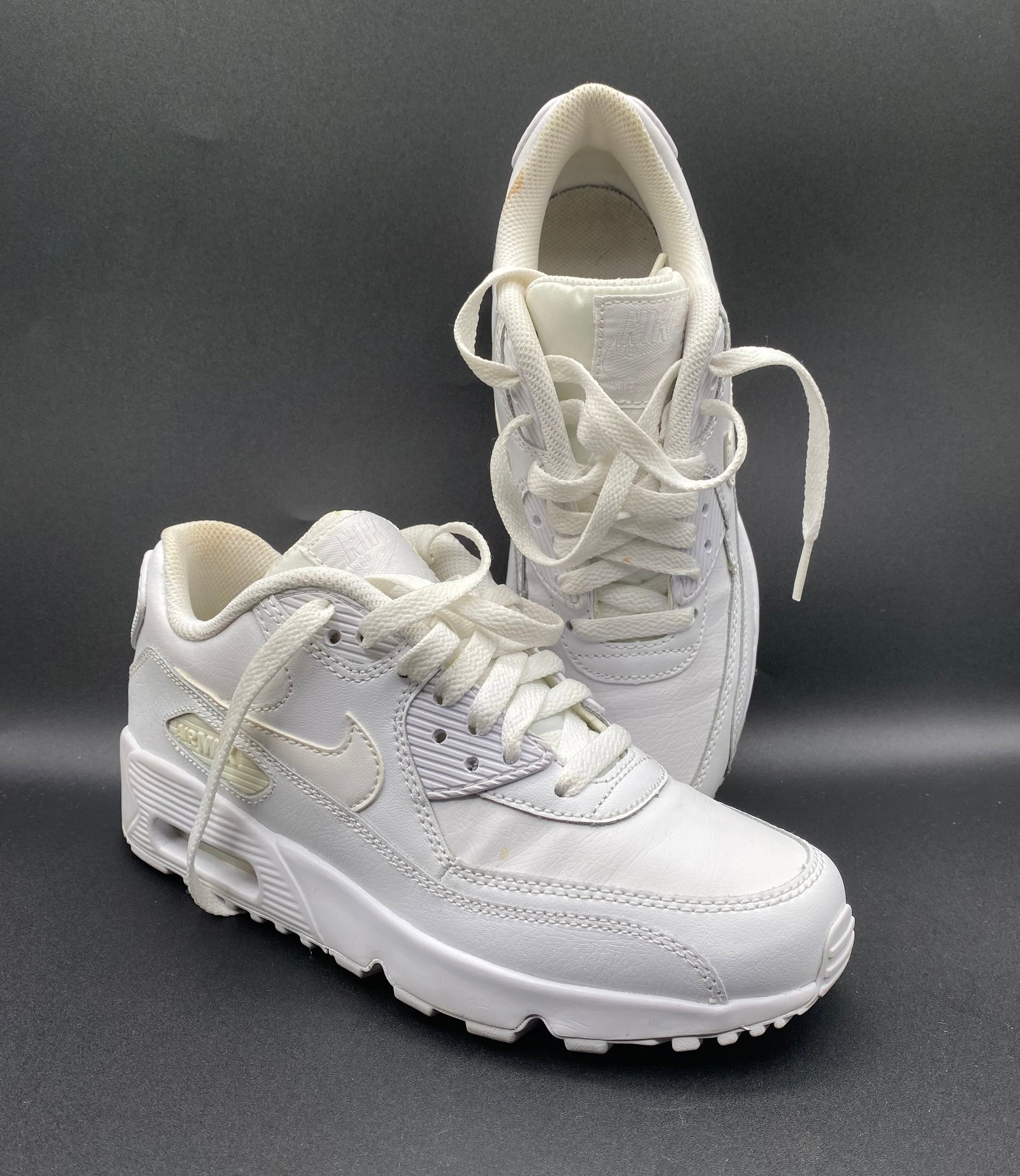 Nike Air Max 90 LTR (GS) "Triple White" Leather Sneakers: Up for auction is a classic pair of Nike Air Max 90 LTR (GS) Sneakers in the timeless "Triple White" colorway (Style # 833412-100). Built with smooth leather uppers, classic TPU plastic accents, padde