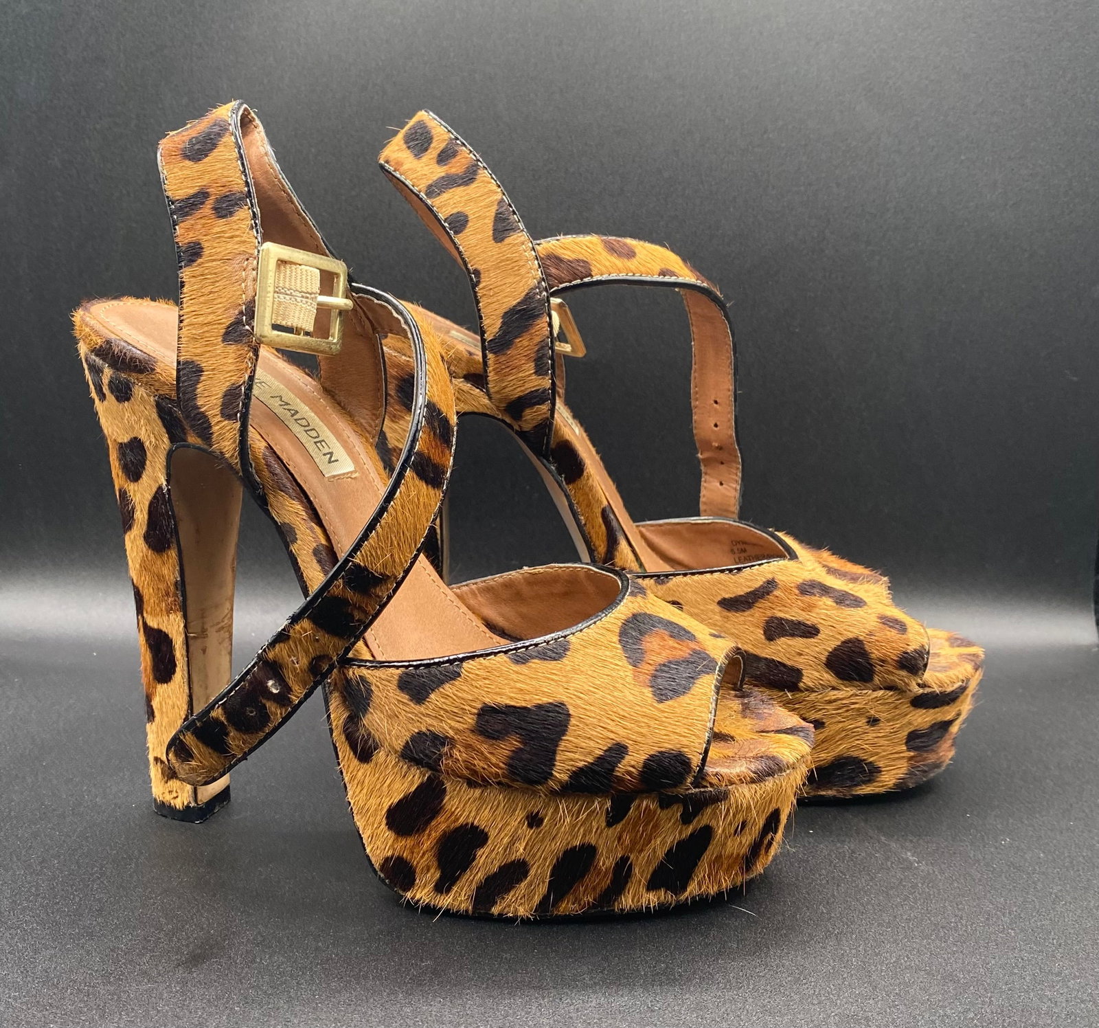 Steve Madden "Dynemite" Leopard Print Calf Hair Platform Heels: Up for auction is a statement pair of Steve Madden "Dynemite" Platform Sandals in a striking leopard print faux calf hair finish. Features bold open-toe front platforms, high block heels, and buckled 