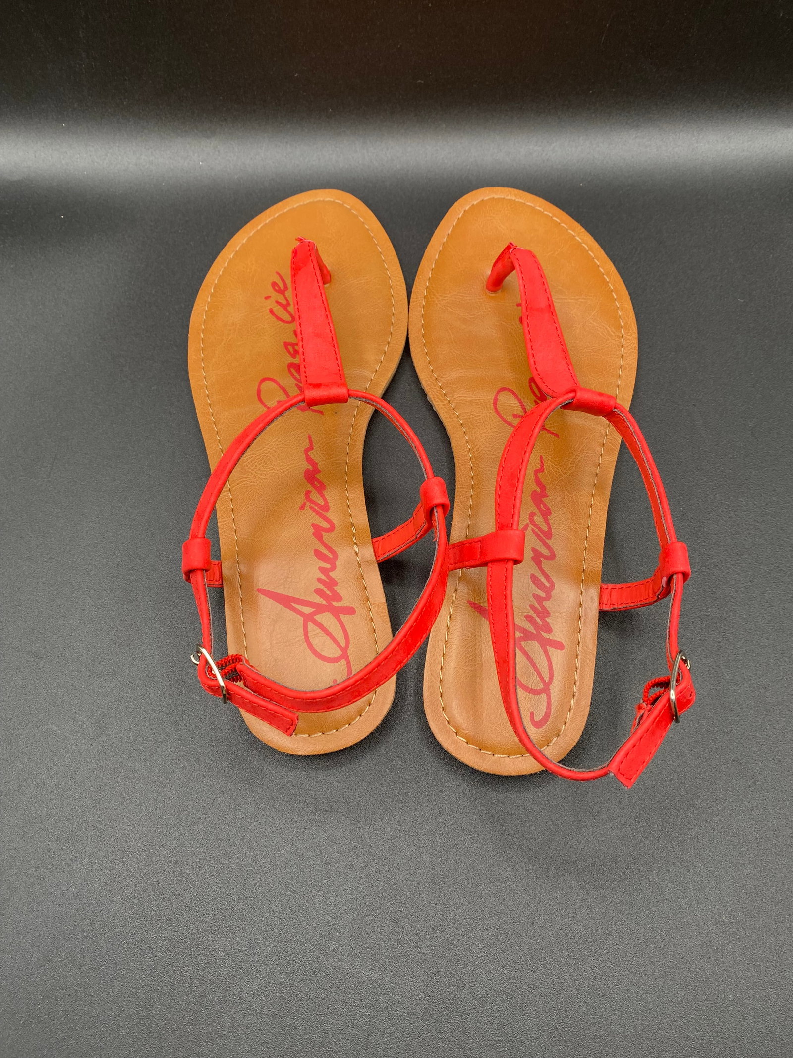 American Rag Cie "Akrista" Coral Red T-Strap Flat Thong Sandals: Up for auction is a vibrant pair of American Rag Cie "Akrista" T-Strap Flat Sandals in a bright coral red PU faux leather. Features classic thong posts, adjustable ankle buckle straps with side
