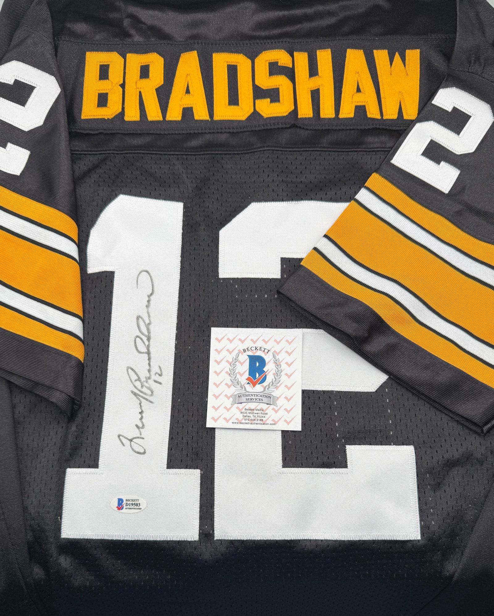 Terry Bradshaw Signed Jersey - Beckett COA: Autographed Terry Bradshaw #12 Pittsburgh Steelers black custom jersey. Inscribed with "12" alongside his hand-signed signature. Includes a Beckett Authentication Services (BAS) Certificate of Authent