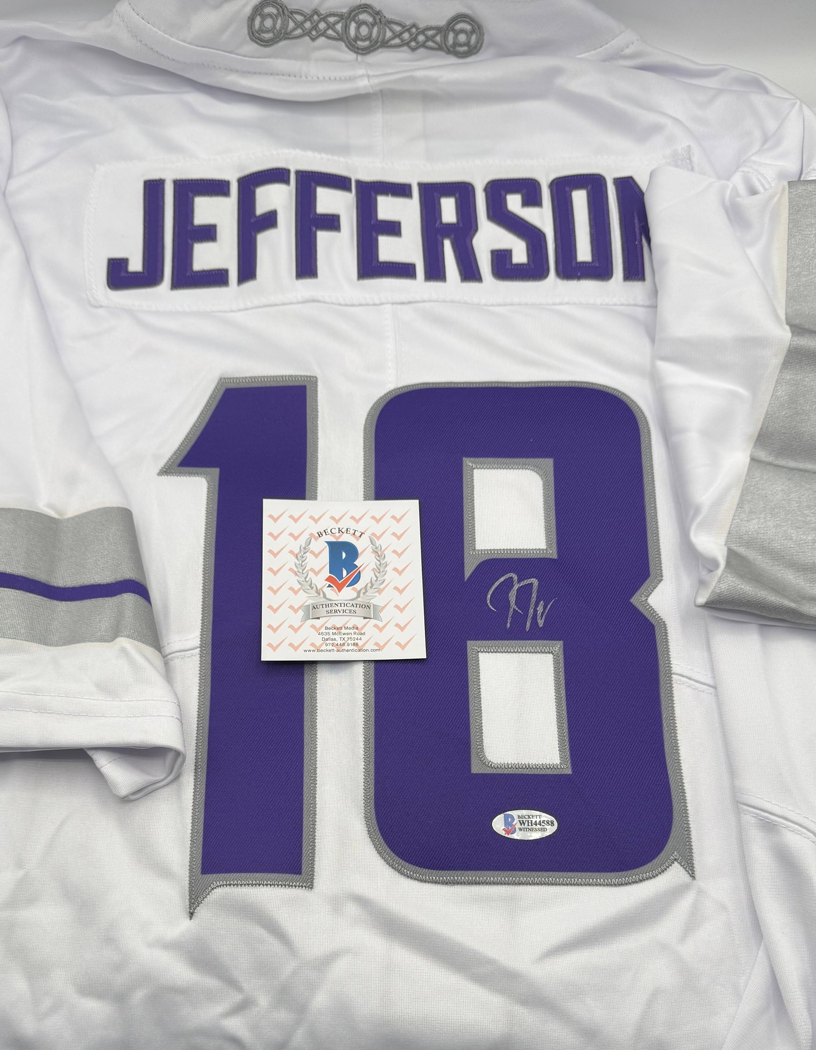 Justin Jefferson Signed Minnesota Vikings #18 Jersey - Beckett Witnessed COA: Autographed Justin Jefferson #18 Minnesota Vikings white style jersey. Signed in silver paint pen on the jersey number. Features Beckett Witnessed Authentication, guaranteeing the signature was observ