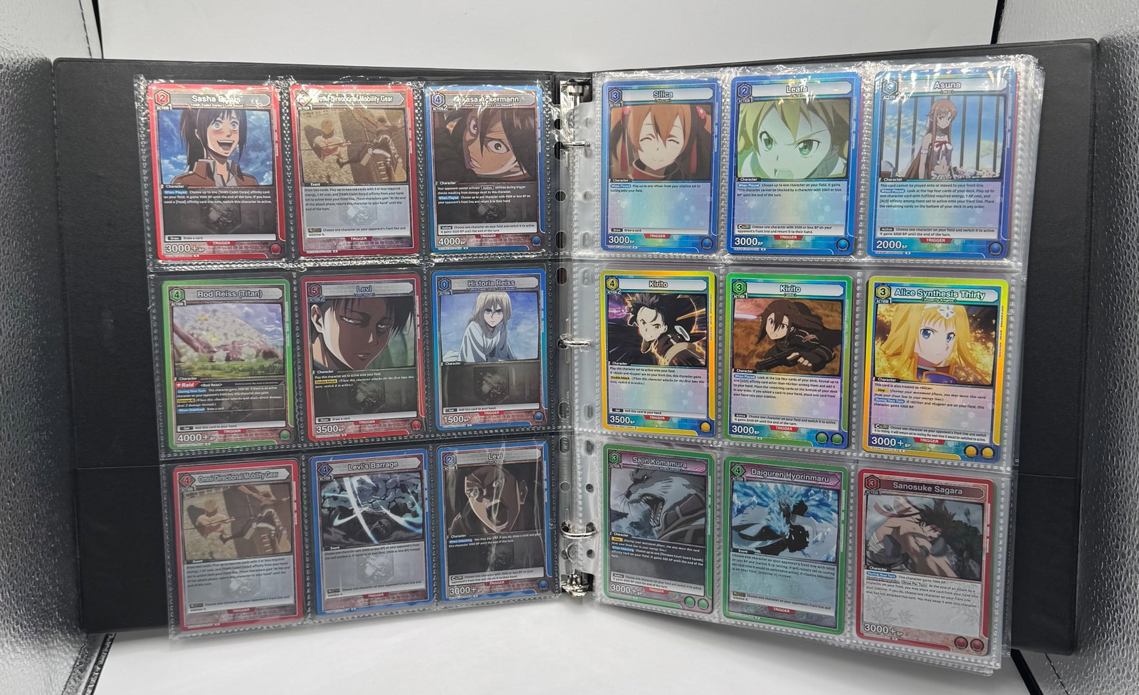 Union Arena Bleach, Attack on Titan, SAO, Black Clover & Rurouni Kenshin Cards Binder: Offered here is an impressive trading card binder containing over 200 Union Arena TCG cards. This lot features popular franchises represented in the Union Arena system, including Bleach, Attack on