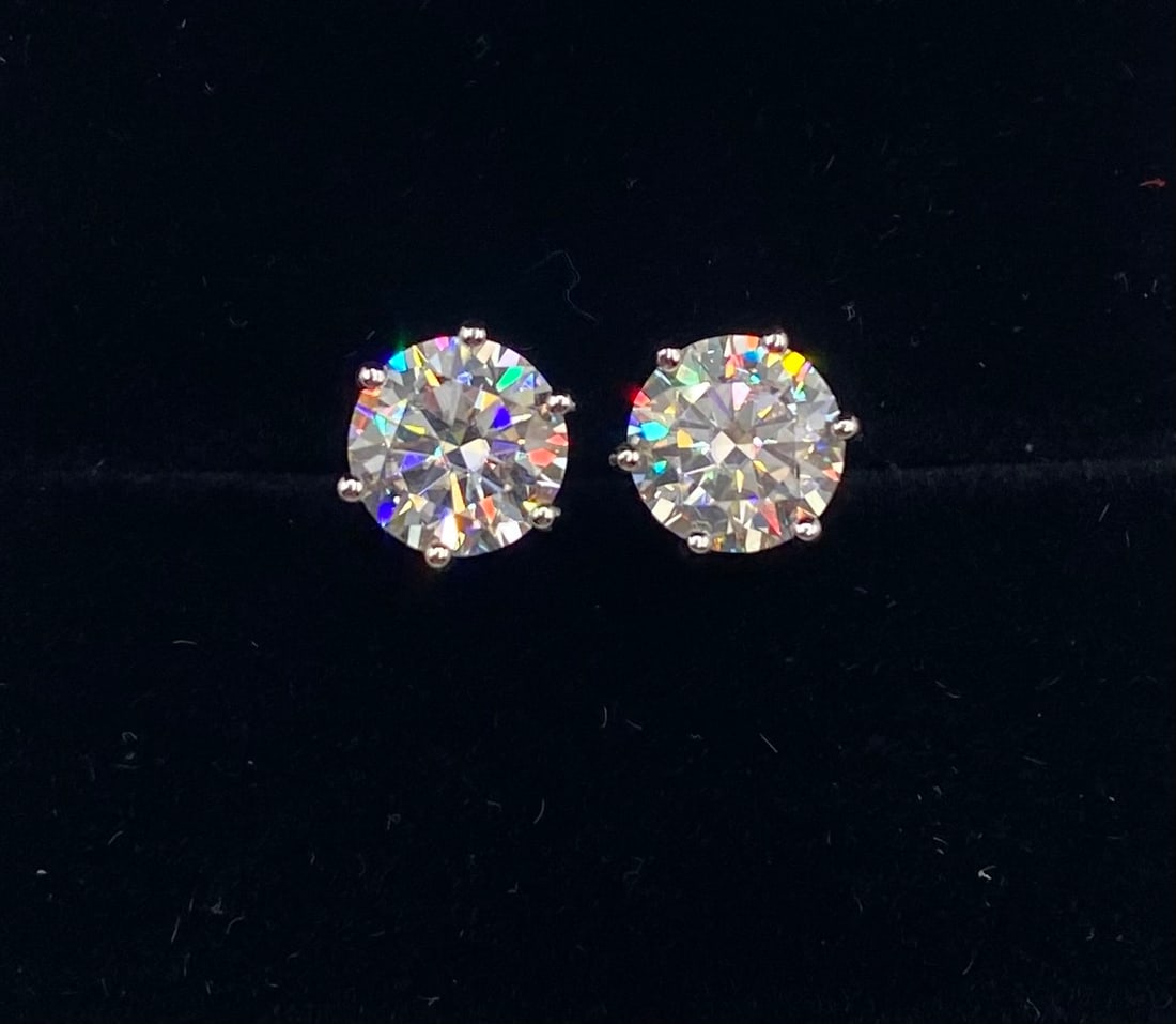 4.00 Carats VVS1 Moissanite White Gold Earrings Certified: Total Carat Weight: 4.00 CTW (2.00 Carats per stone) Stone Type: Lab-Created Moissanite (Passes Thermal/Diamond Tester) Color Grade: D (Colorless) Clarity Grade: VVS1 Metal Composition: 18K White Gold