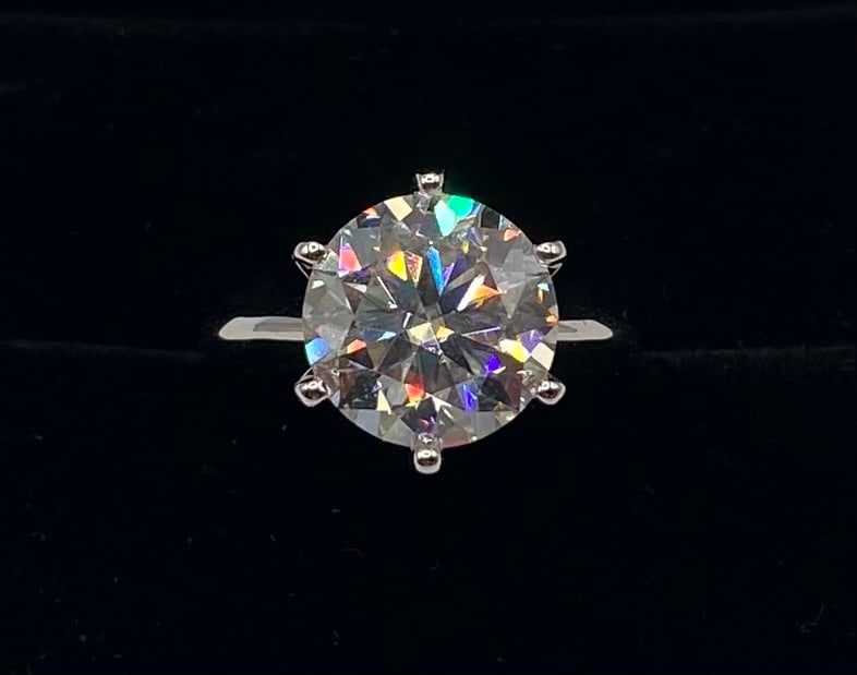 5 Carats VVS1 Moissanite Ring: Item Details: Total Carat Weight: 5.00 Carats Gemstone: Lab-Created Moissanite Stone Color: D (Colorless) Clarity: VVS1 (Virtually Flawless) Metal: 18K Gold Plated over 925 Sterling Silver Ring Size: 