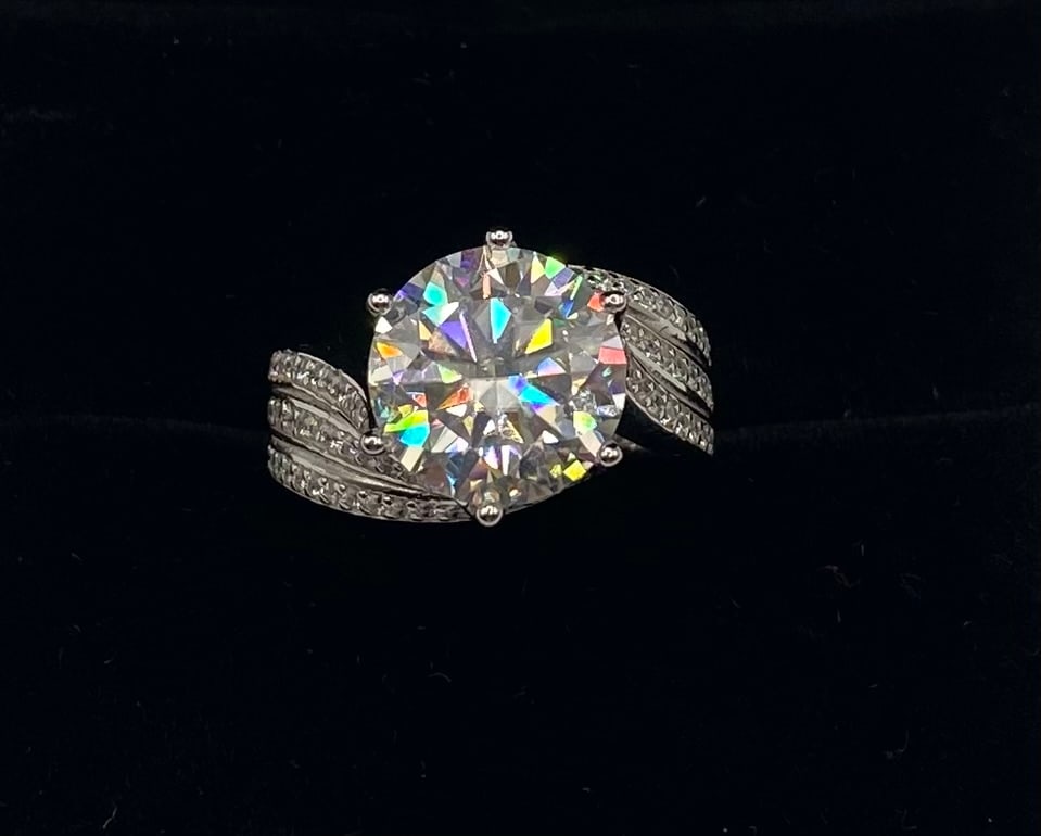 5 Carats Sparkling VVS1 Moissanite Ring: Item Details: Total Carat Weight: 5.00 Carats Gemstone: Lab-Created Moissanite Stone Color: D (Colorless) Clarity: VVS1 (Virtually Flawless) Metal: 18K Gold Plated over 925 Sterling Silver Ring Size: 
