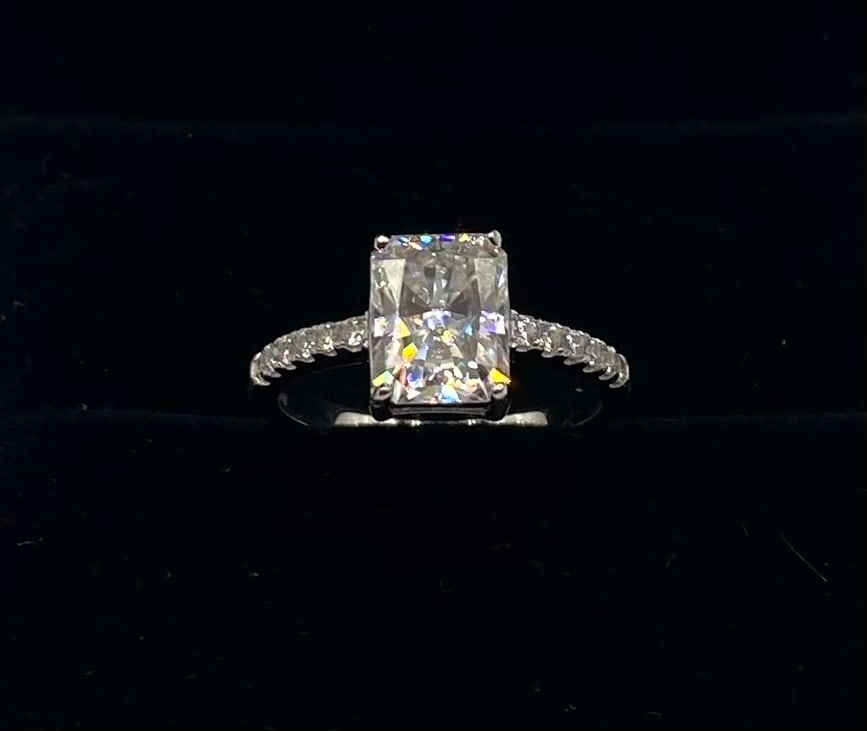 Radiant VVS1 Moissanite Ring: Item Details: Total Carat Weight: 3.00 Carats Gemstone: Lab-Created Moissanite Stone Color: D (Colorless) Clarity: VVS1 (Virtually Flawless) Metal: 18K Gold Plated over 925 Sterling Silver Ring Size: 