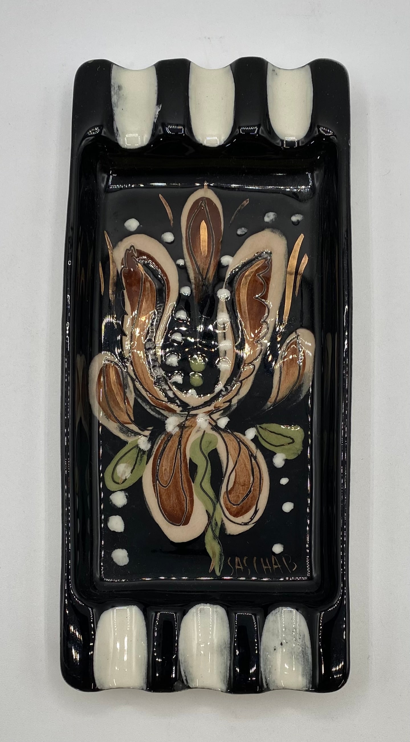 Mid-Century Modern Sascha Brastoff Floral Rectangular Ceramic Ashtray: A collectible Mid-Century Modern California art pottery rectangular ashtray tray by Sascha Brastoff, featuring an abstract floral motif in earthy brown, tan, and green tones with white enamel and