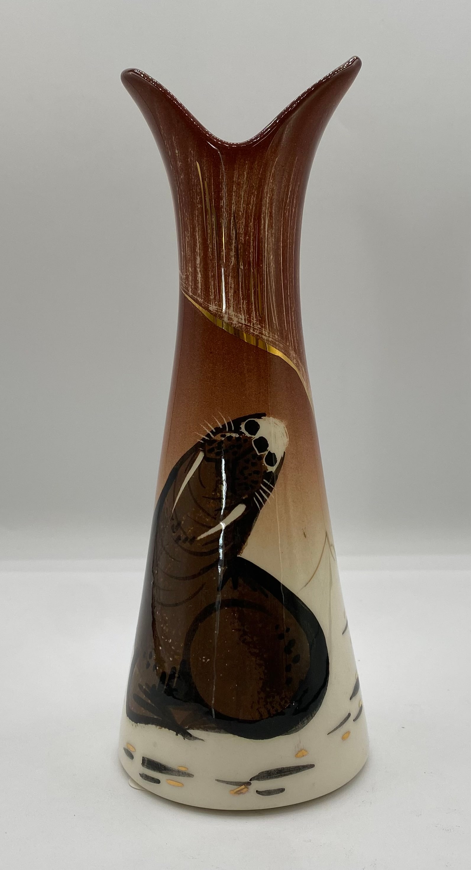 Sascha Brastoff Walrus/Seal Tapered Bud Vase - 8.5: A stylized Mid-Century Modern California art pottery tapered bud vase with a pinched/flared rim by Sascha Brastoff, featuring a hand-painted walrus/seal motif amidst snow-capped mountain accents and g