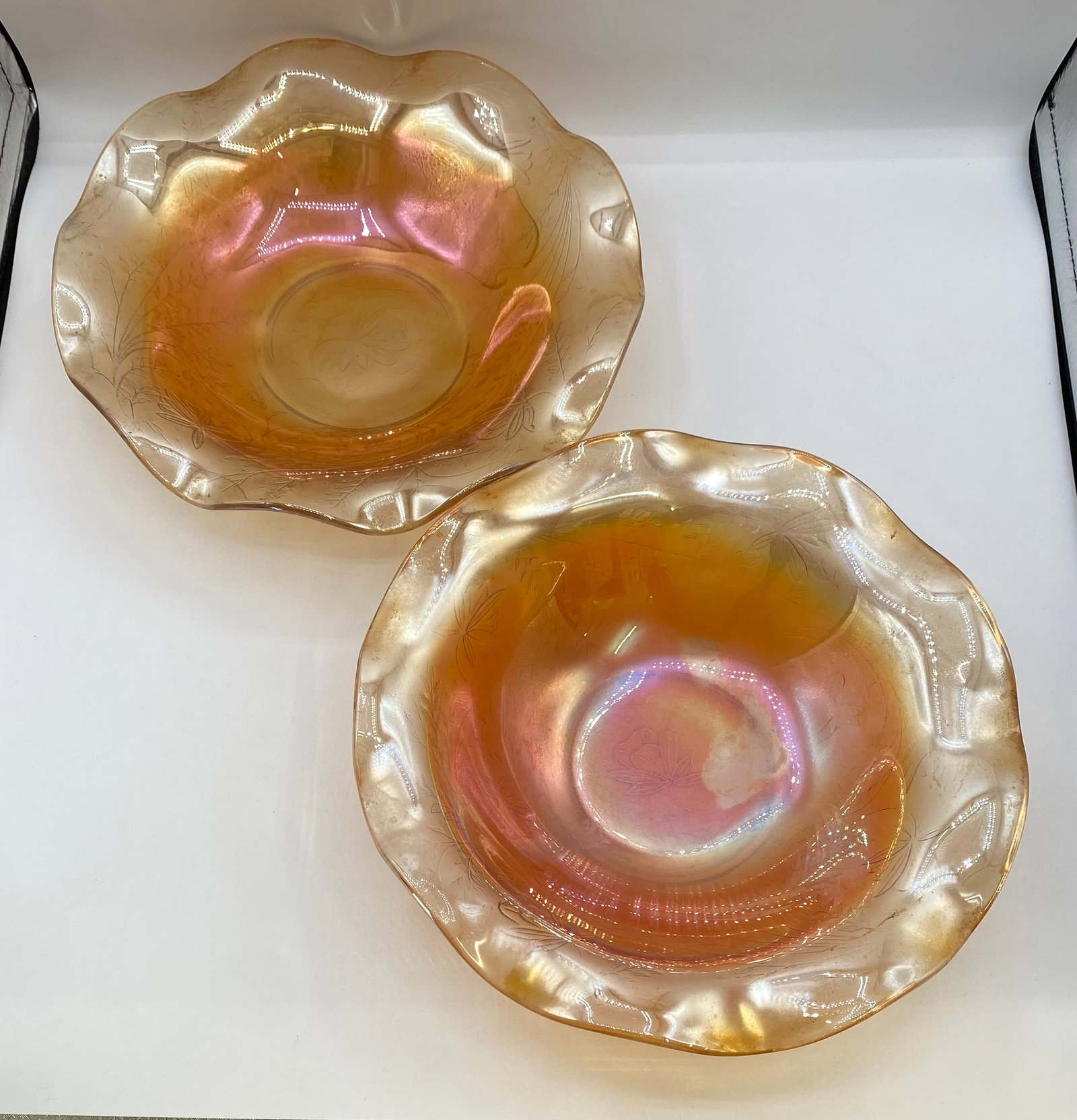 Pair of Vintage Jeanette Glass Marigold Carnival Glass "Iris & Herringbone" Ruffled Bowls: Up for auction is a matching pair of vintage marigold carnival glass bowls in the popular "Iris & Herringbone" pattern, produced by Jeanette Glass Company. Each bowl features an iridescent marigold sh