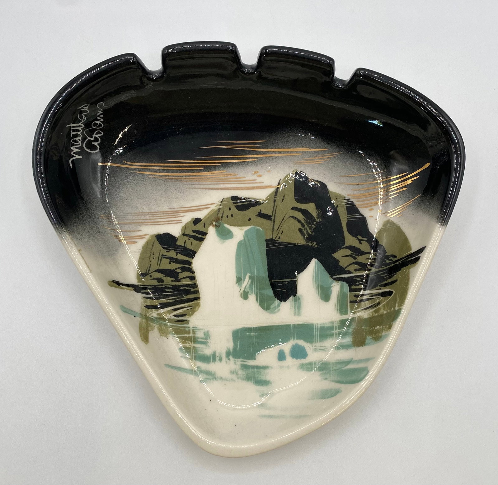 Matthew Adams California Pottery "Alaska" Series Ashtray #148A: Up for auction is a mid-century modern ceramic triangular/freeform ashtray by California artist Matthew Adams from his "Alaska" series. Hand-painted with a mountainous landscape scene accented in blac