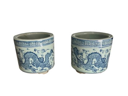 Pair of Vintage Blue and White Chinese Dragon Cachepots: Pair of vintage blue and white Chinese cachepots with a greek key border and dragon motif. Perfect little vases or planters. DIMENSIONS: 4"W x 4"D x 4"H. CONDITION: Excellent. No Reserve.