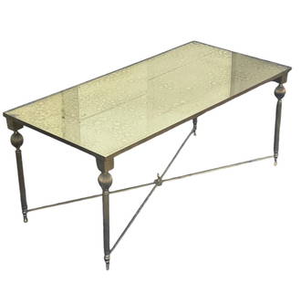 Vintage Jansen Style Eglomise Brass Coffee Table: A vintage brass and eglomise mirrored glass coffee table in the manner of Maison Jansen. DIMENSIONS: 39.5"W x 19.5"D x 17"H. CONDITION: Excellent. No Reserve.