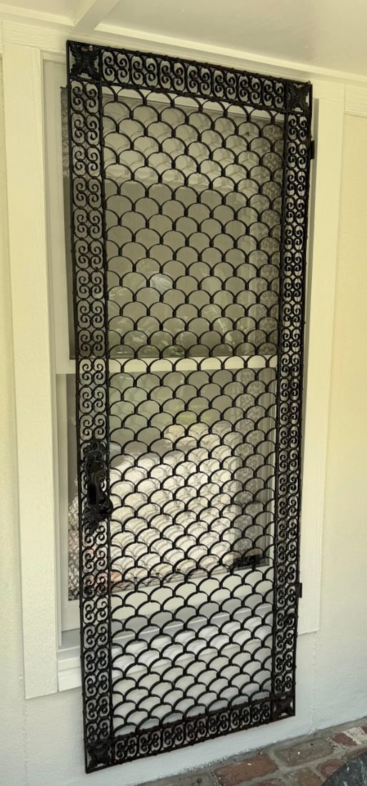 An antique wrought iron door cover (1 of 4)