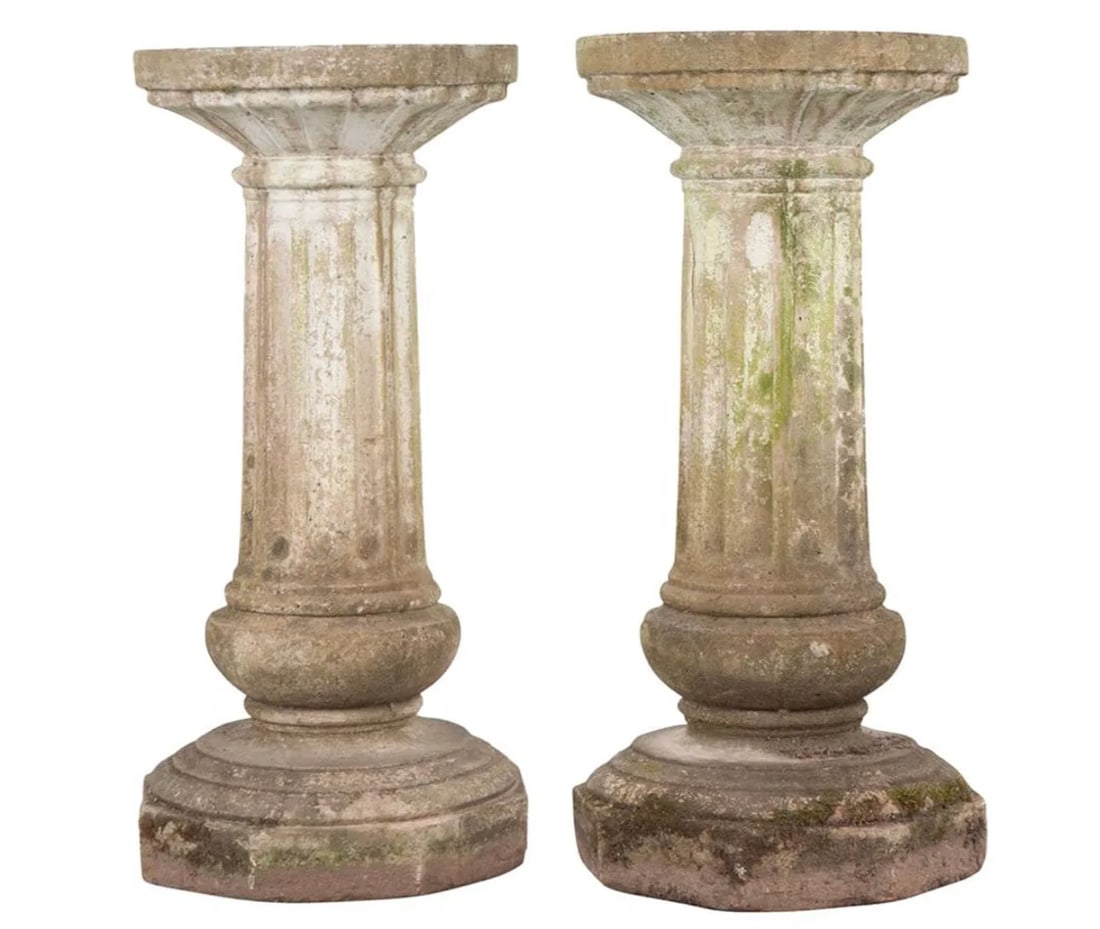 A pair of antique English fluted stone pedestals: A pair of antique English fluted stone pedestals. There is a white painted patina that has been fading with age and use, giving them an added beautiful layer. DIMENSIONS: 15.5"D x 34.25"H