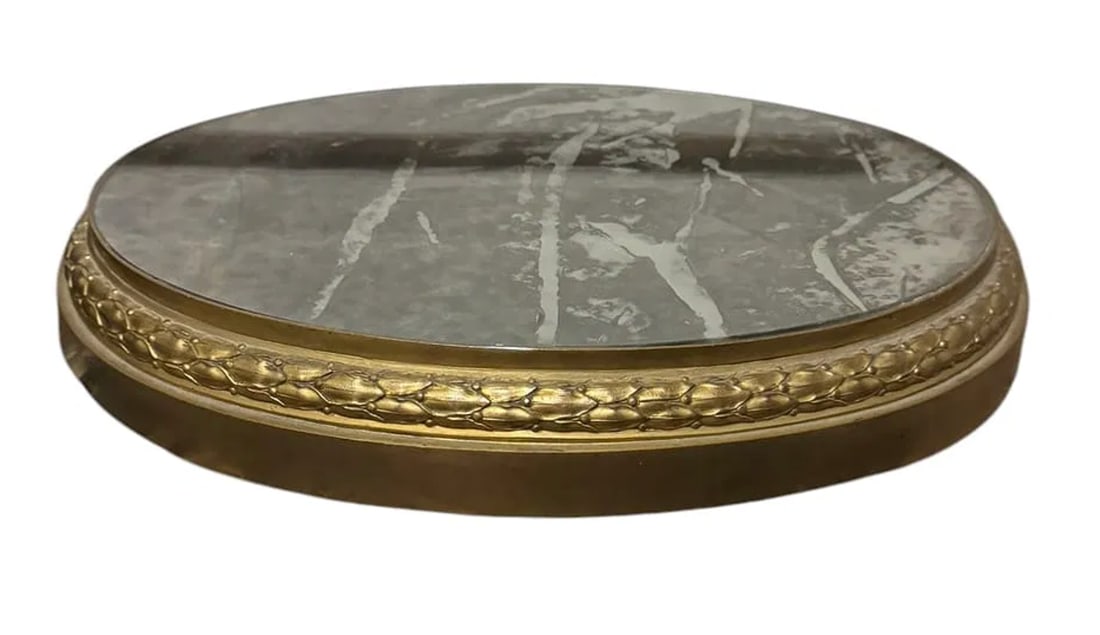 Pair of antique oval mirrored plateaus with a brass wreath border: Pair of antique oval mirrored plateaus with a brass wreath border. DIMENSIONS: 15.5'W X 12.25"D X 2.25"H