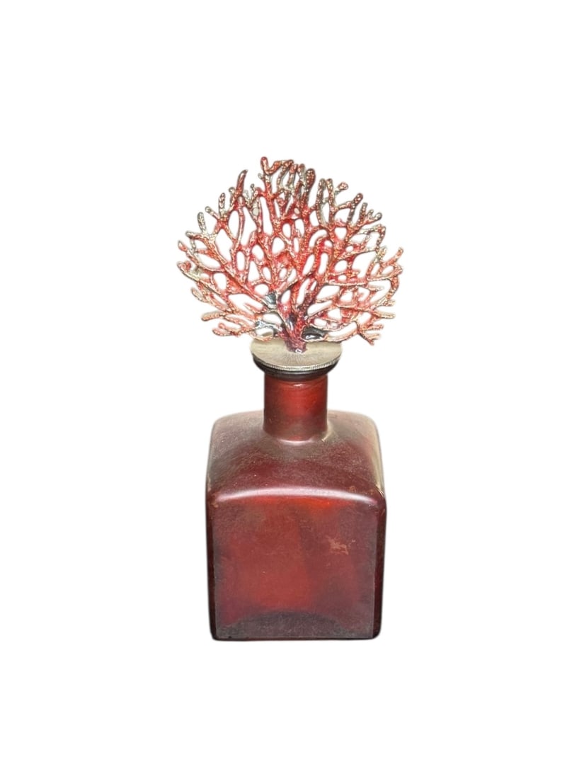 A vintage red glass perfume bottle with coral fan stopper: A vintage red glass perfume bottle with coral fan stopper. DIMENSIONS: 3"W x 3"D x 7”H. This item is located in NYC.