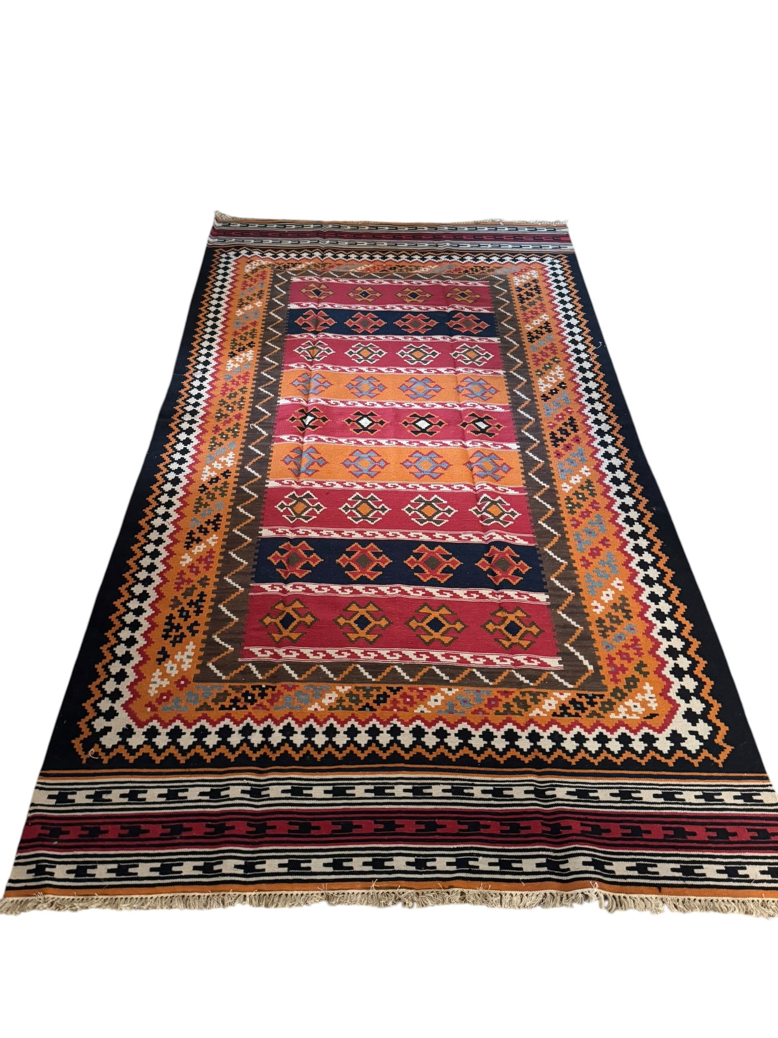 Red Argentinian rug: Red Argentinian rug. DIMENSIONS: 61.5”W x 113”L