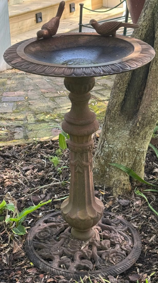 An antique iron birdbath with a floral detail base and two iron birds set atop the basin (1 of 6)